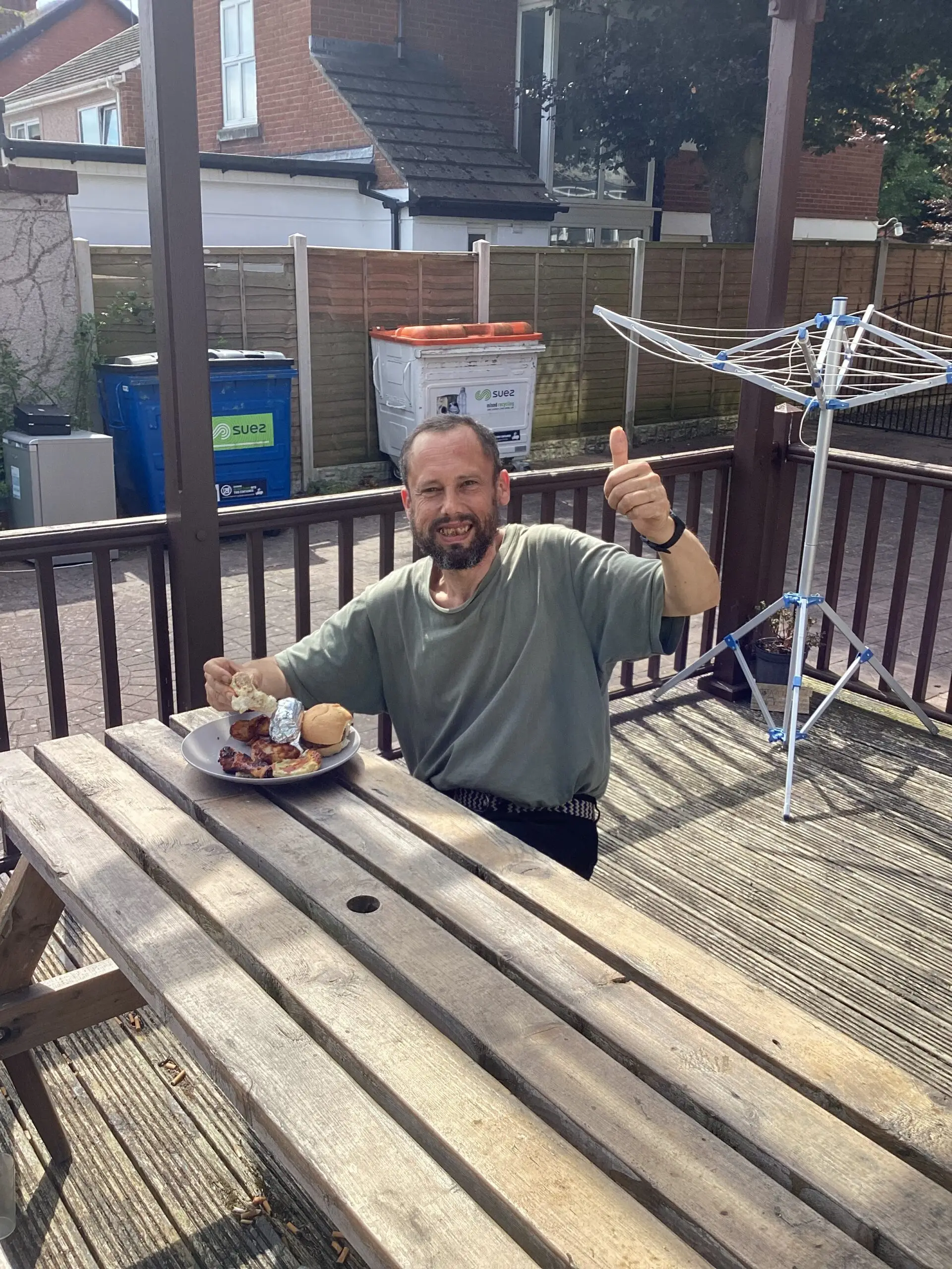 resident eating food on picnic bench