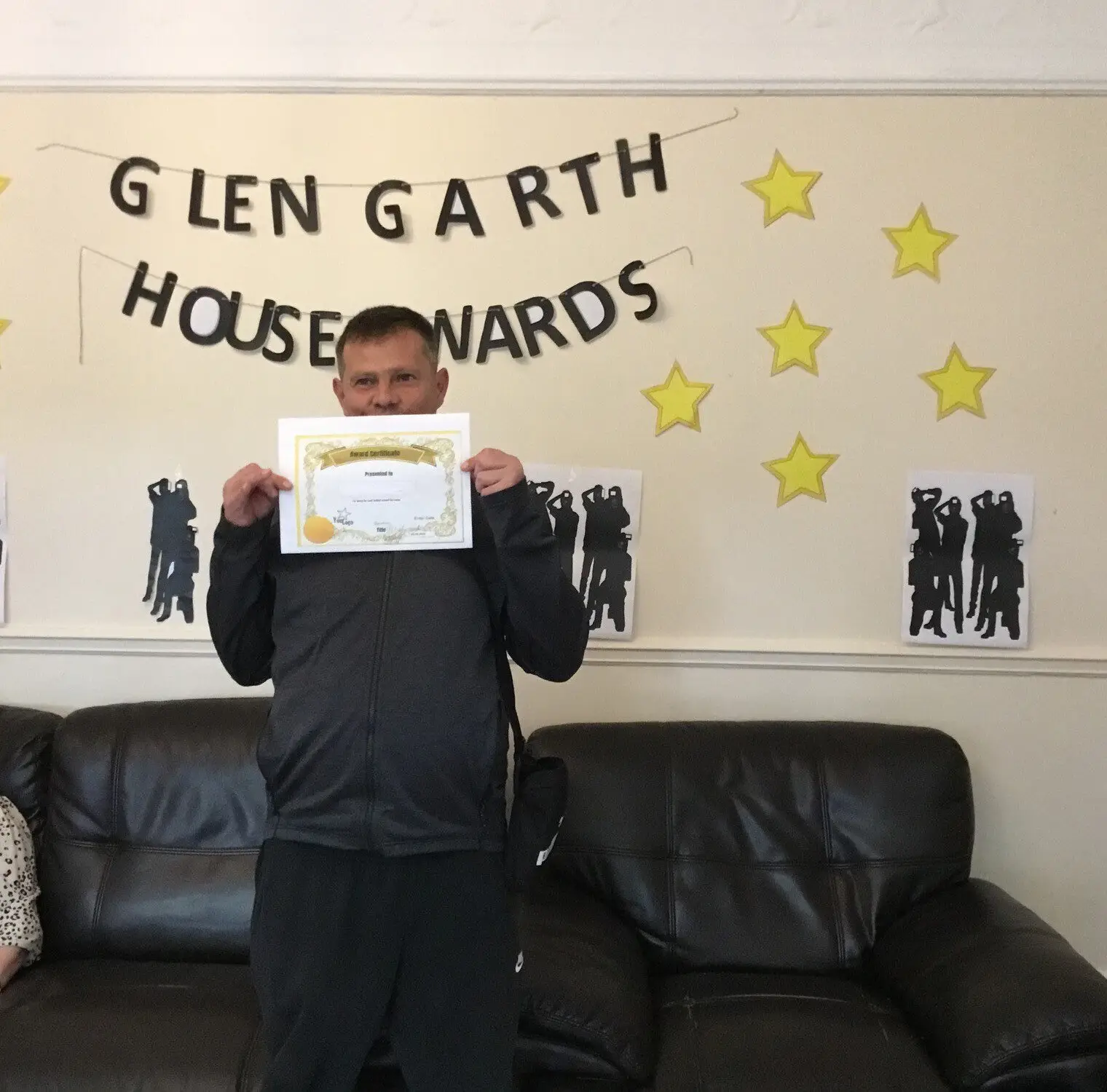 resident with award certificate