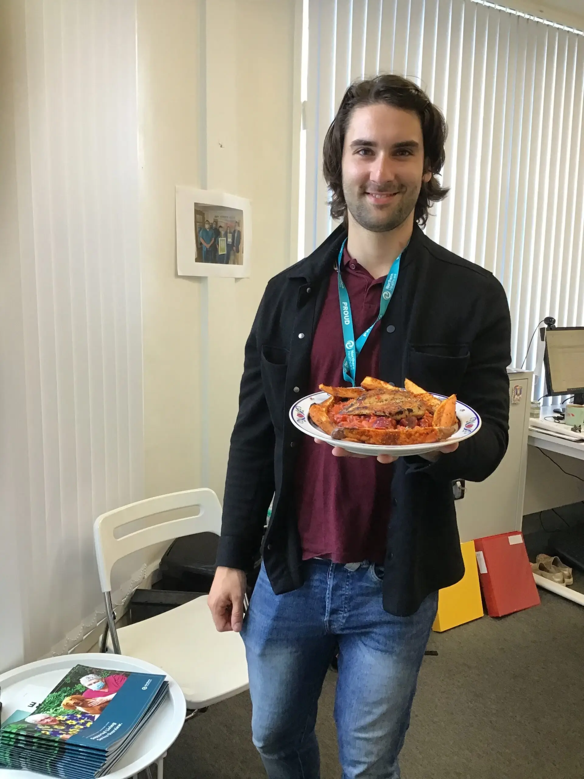 team member holding plate of food