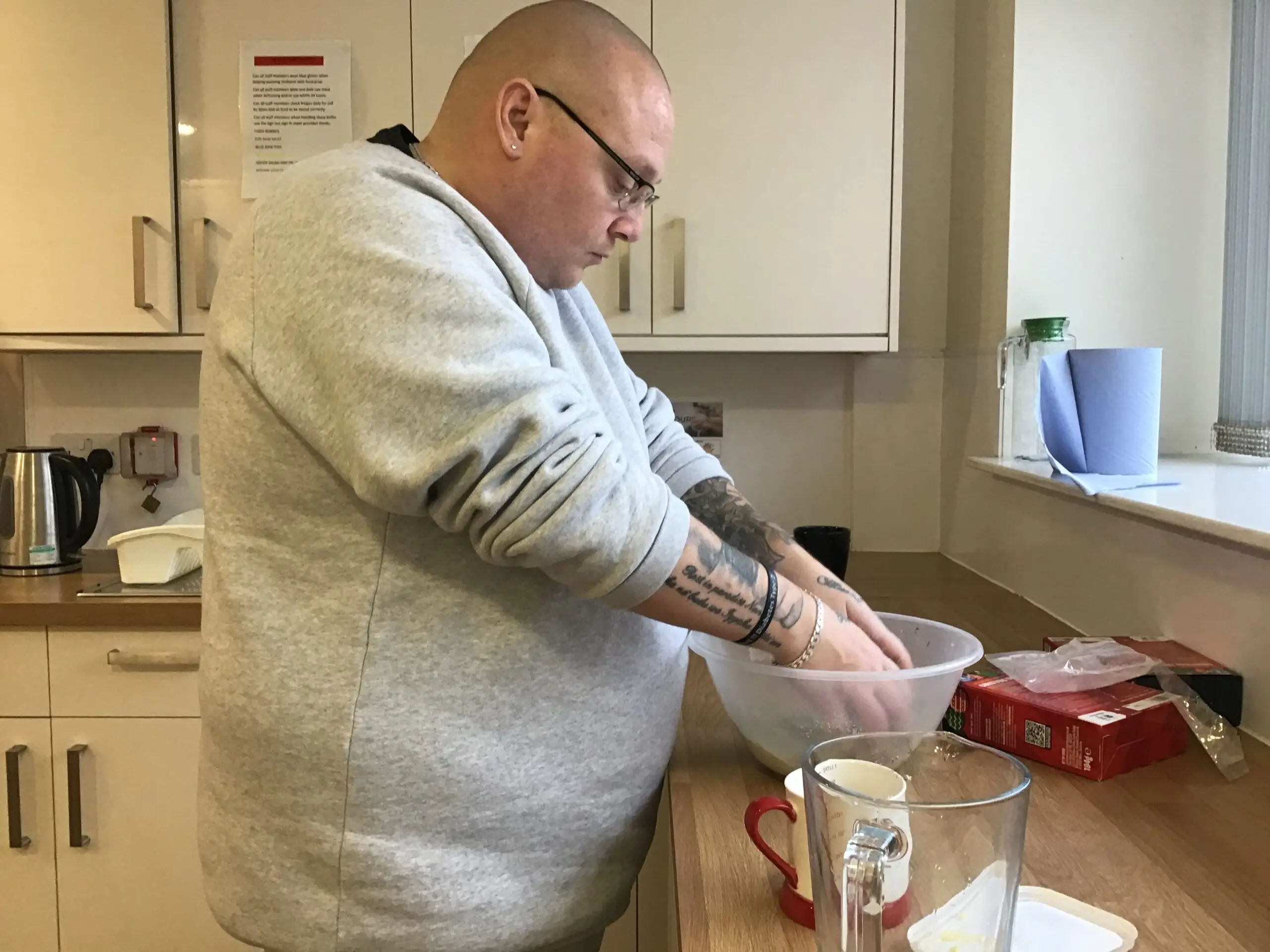 resident mixing biscuit mix in bowl