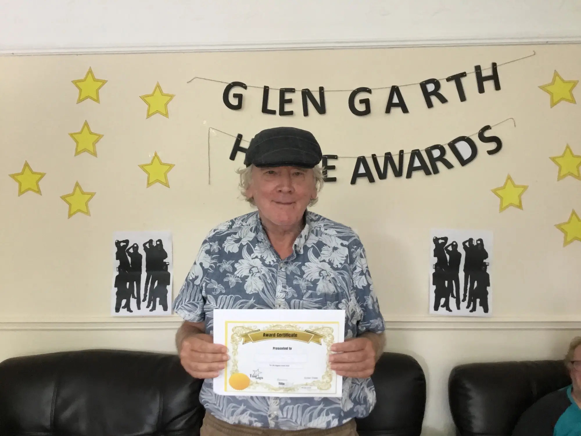 resident with award certificate