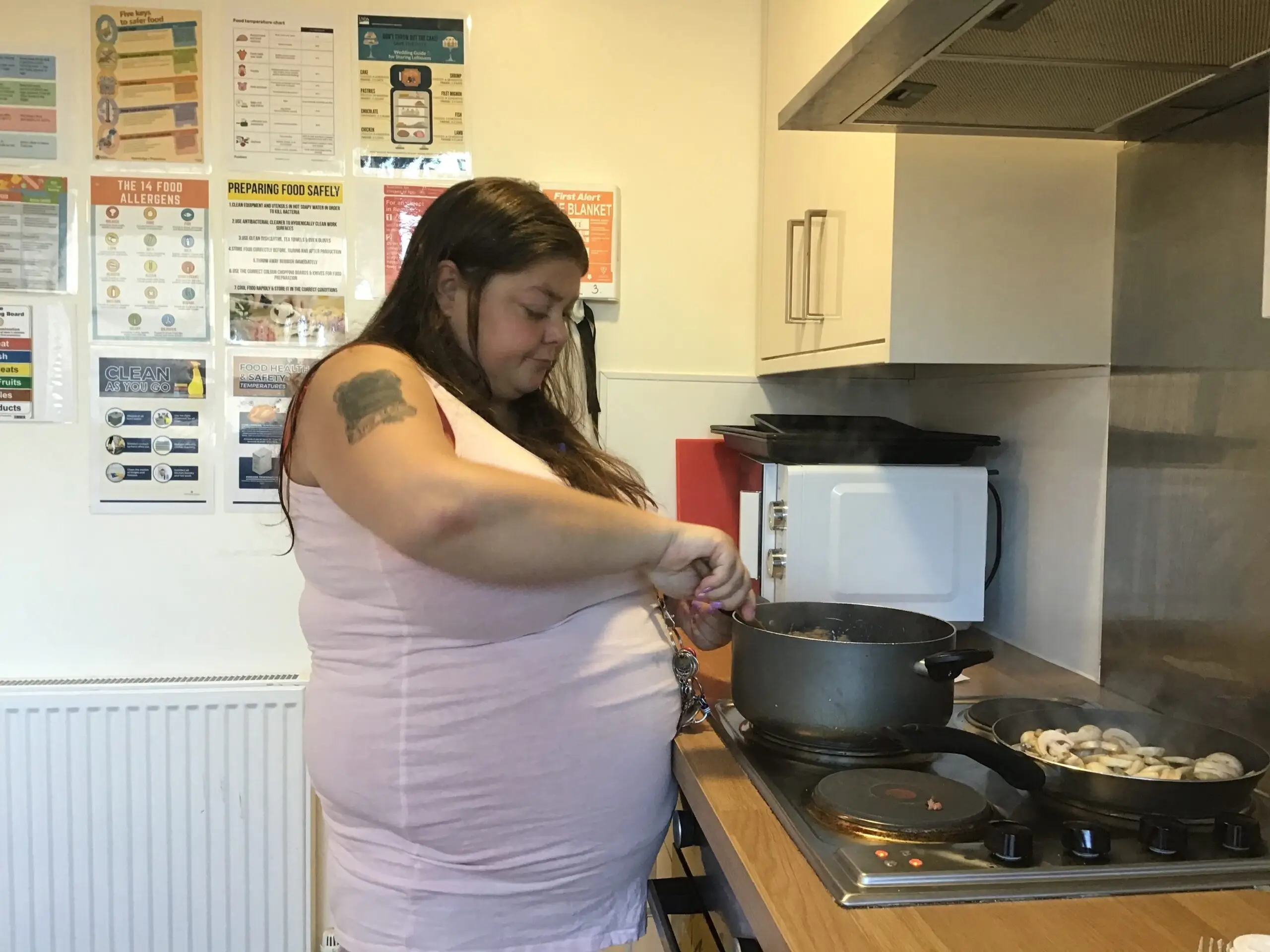 resident stirring ingredients in pan on stove