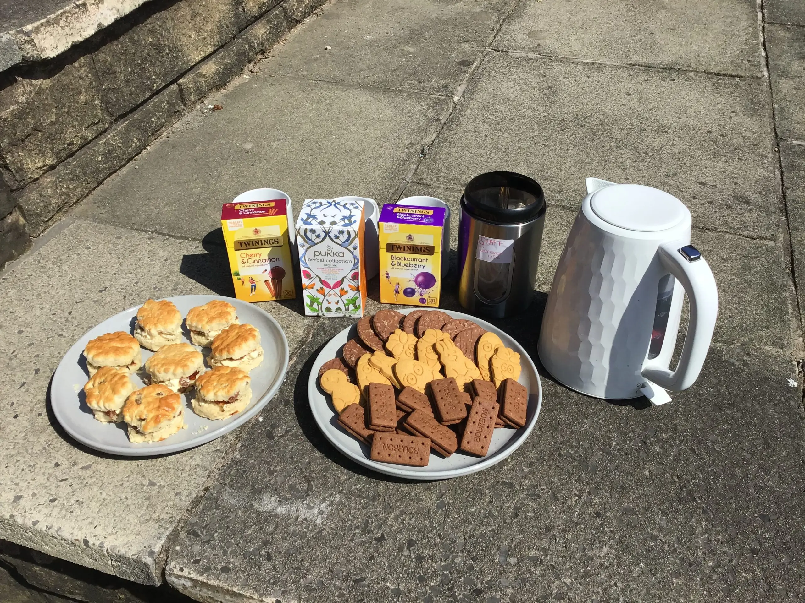 plate of scones and biscuits, and tea bags and kettle