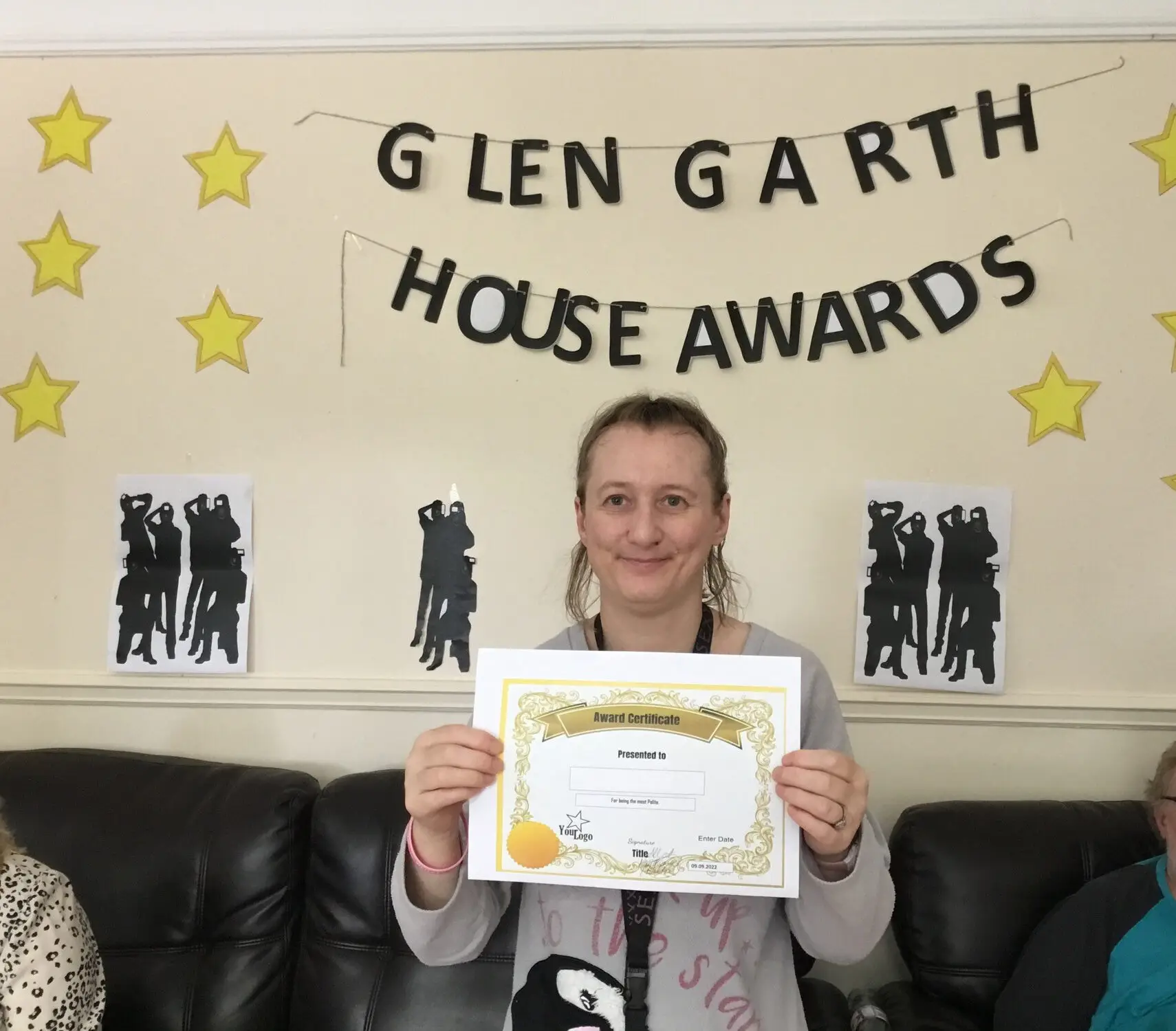 resident with award certificate