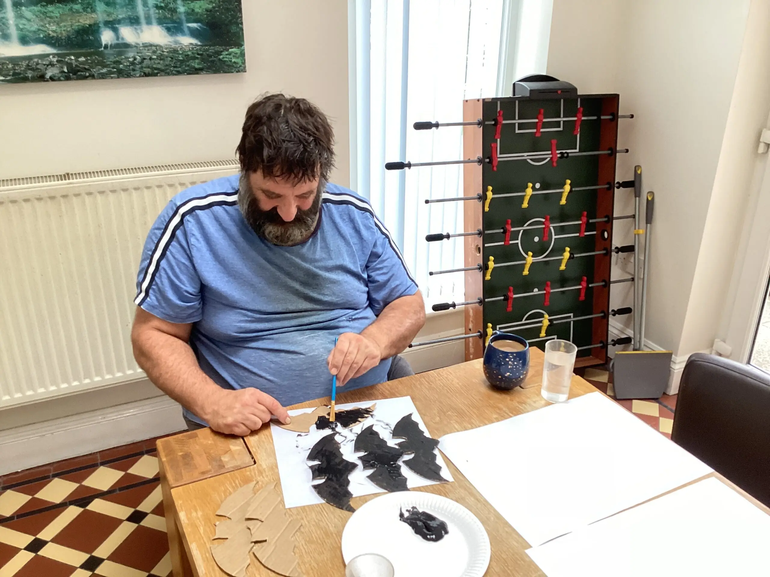 resident creating cardboard bat decorations