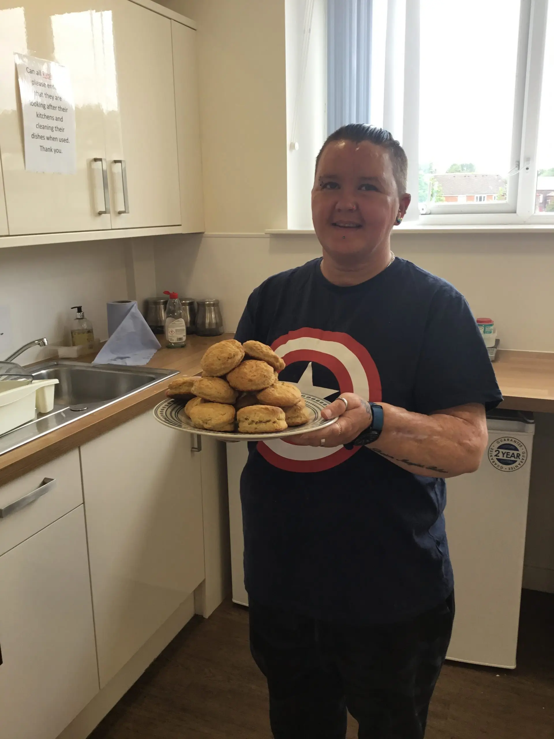 resident holding tray of home made scones