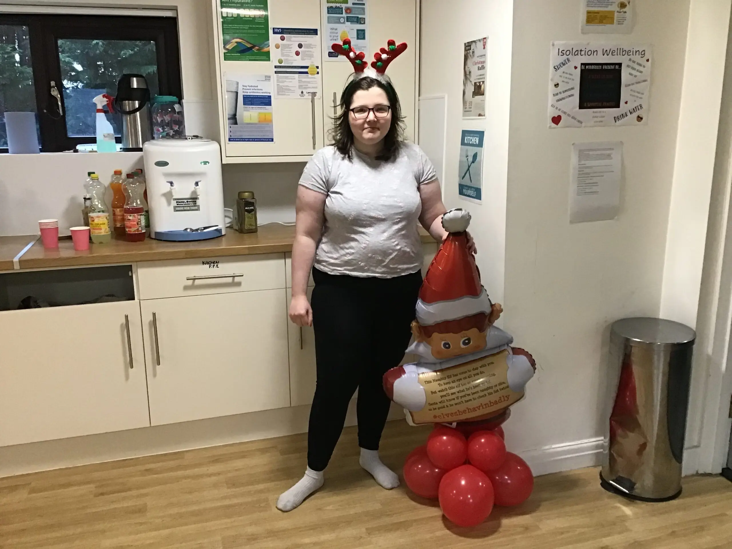 resident posing with a santa decoration
