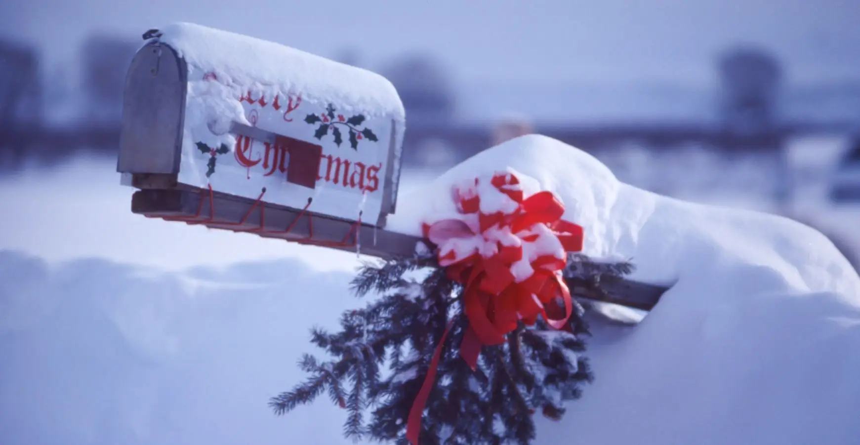 post box covered in thick layer of snow