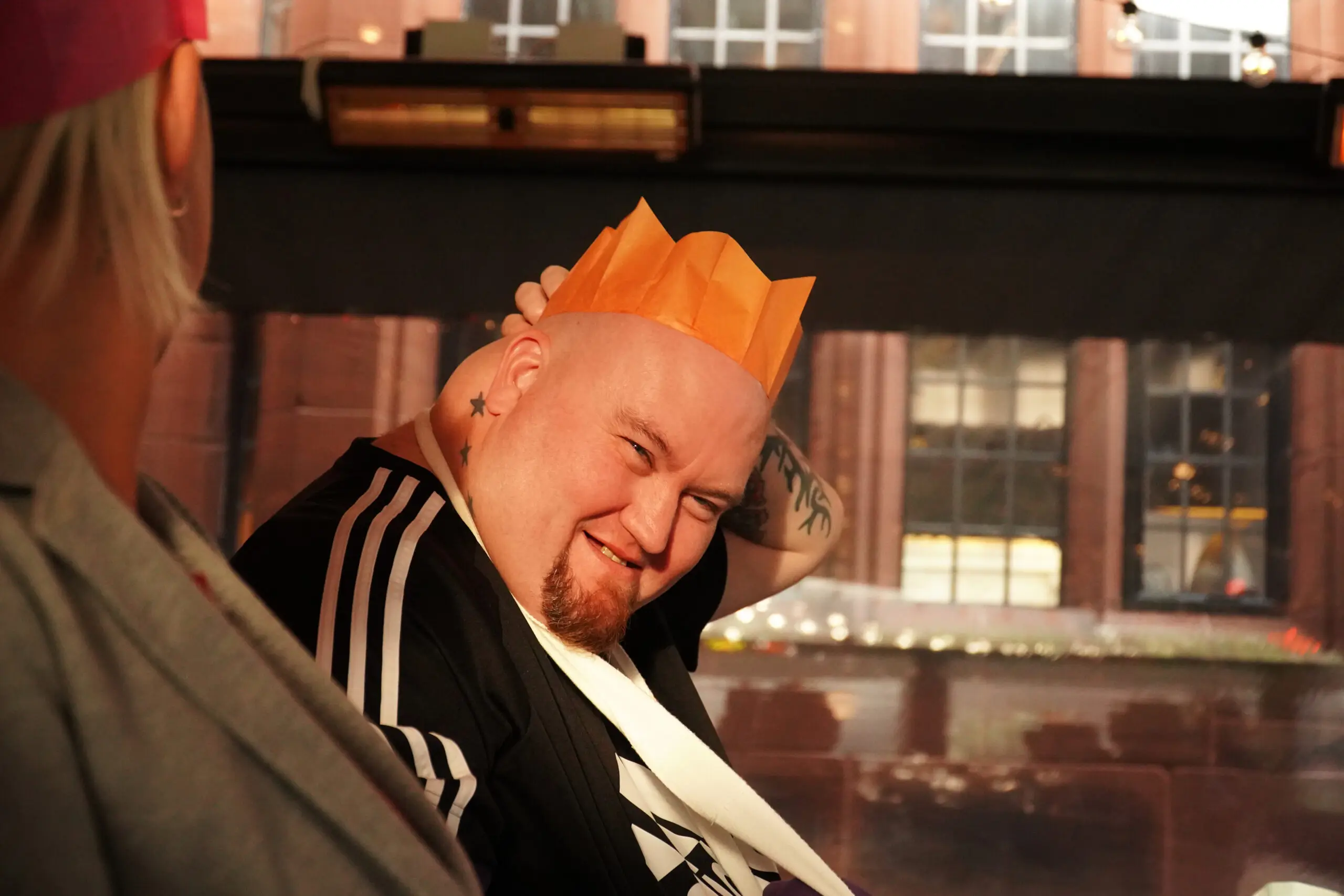 resident in orange paper party hat