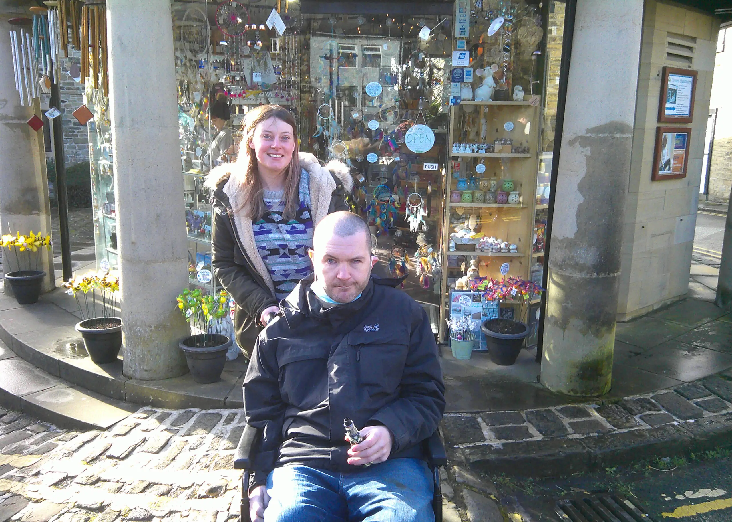 resident and team member in front of antique shop window