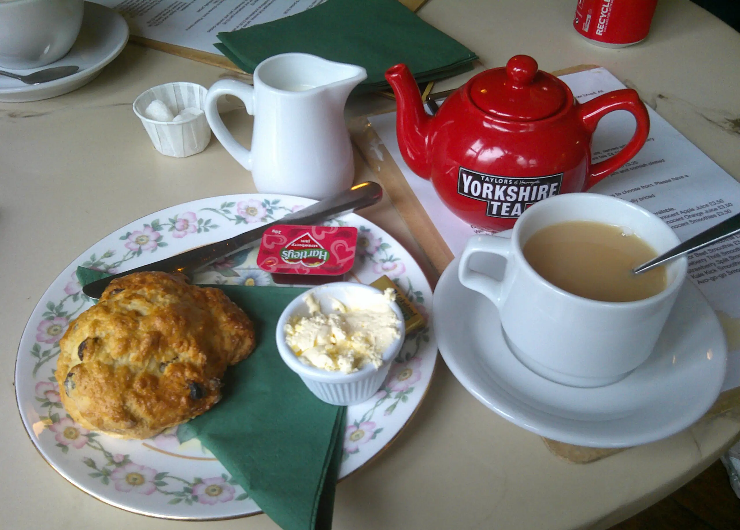 scone and cup of tea with red teapot