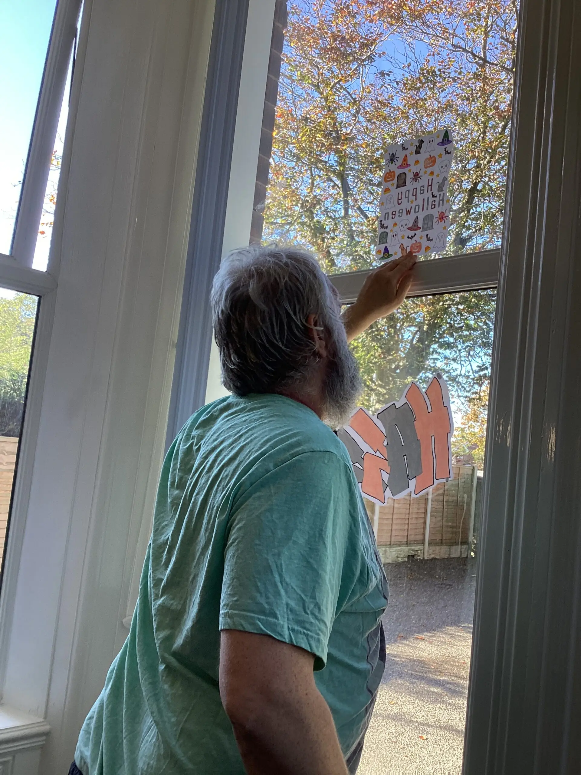 resident putting up Halloween decorations