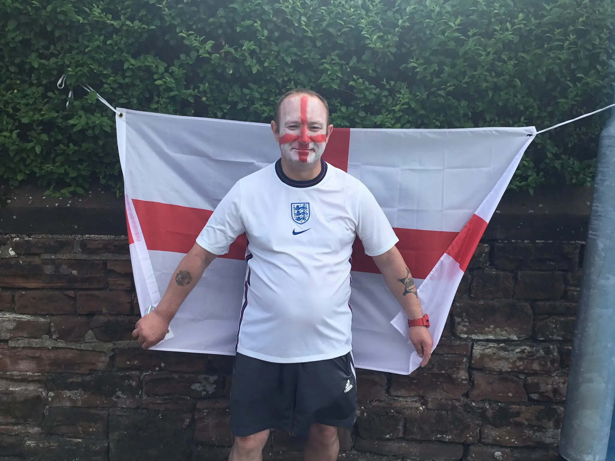 Life at Glen Garth: resident stood in front of england flag wearing england top and england flag painted on face