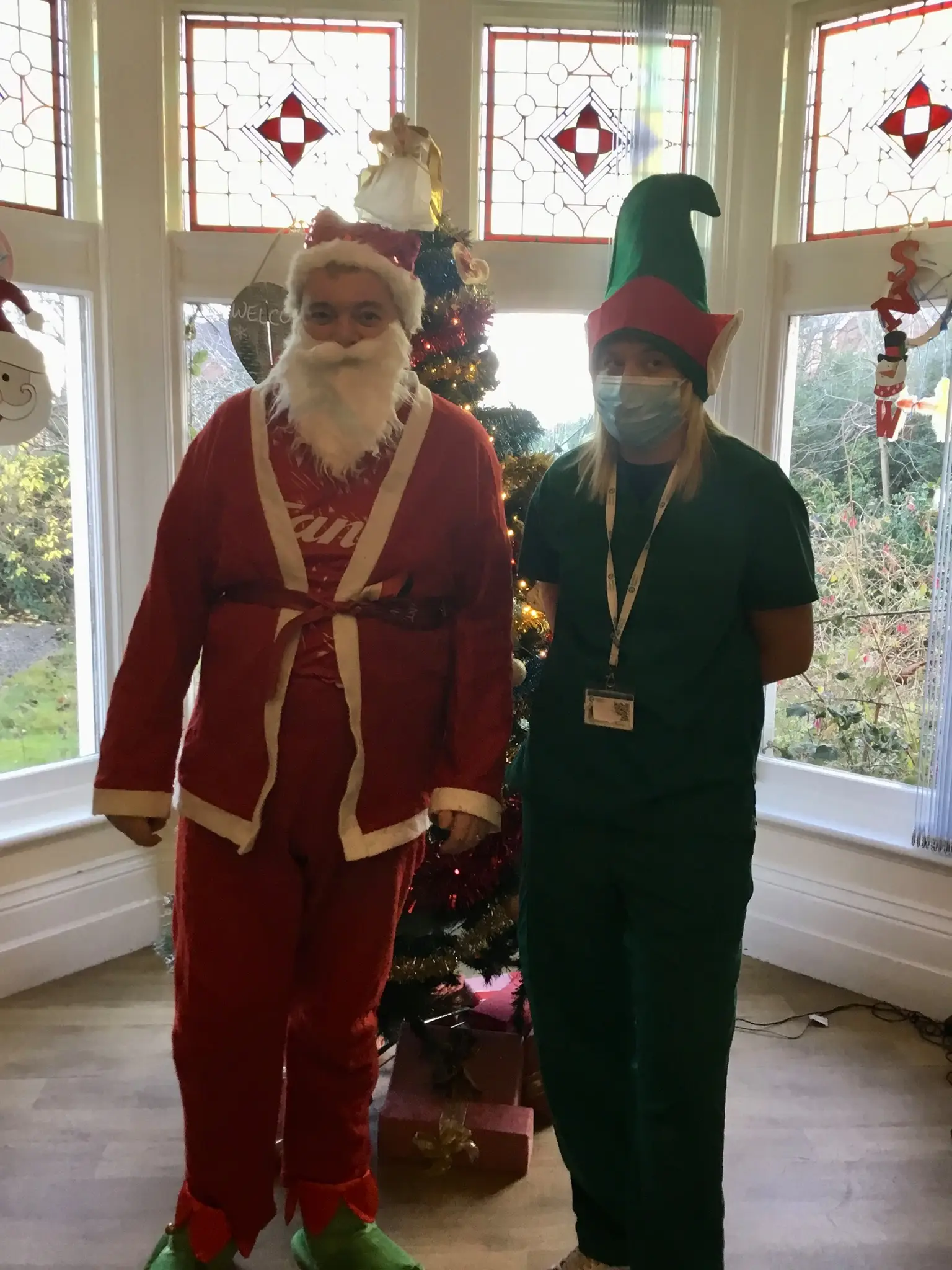 resident and team members dressed as santa and an elf