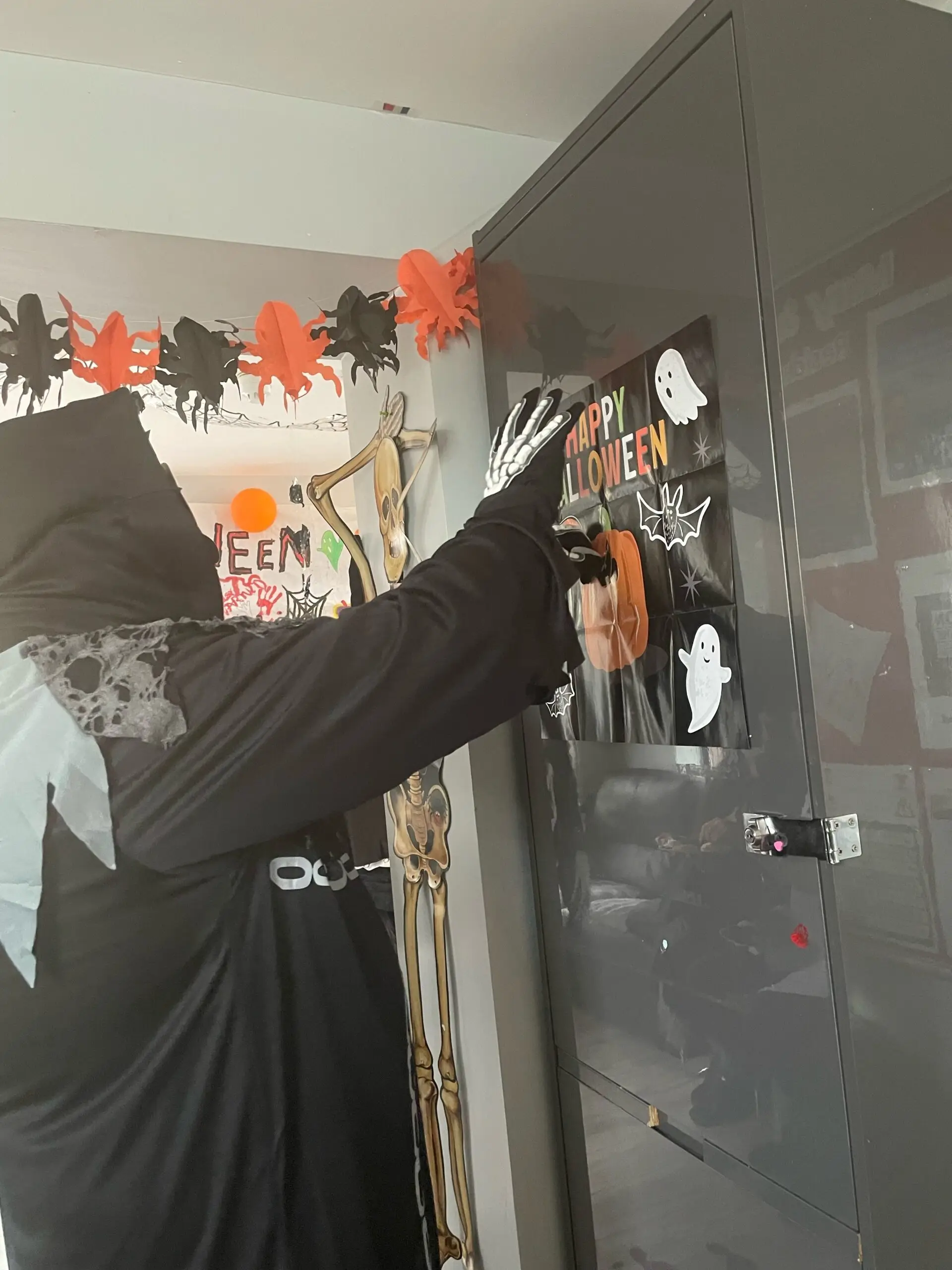 resident in halloween costume pinning mouth on pumpkin