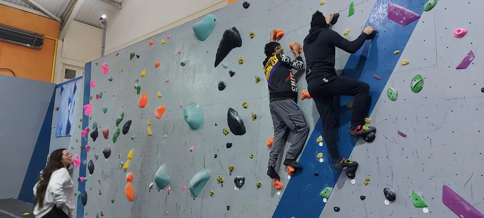 residents and team members on climbing wall