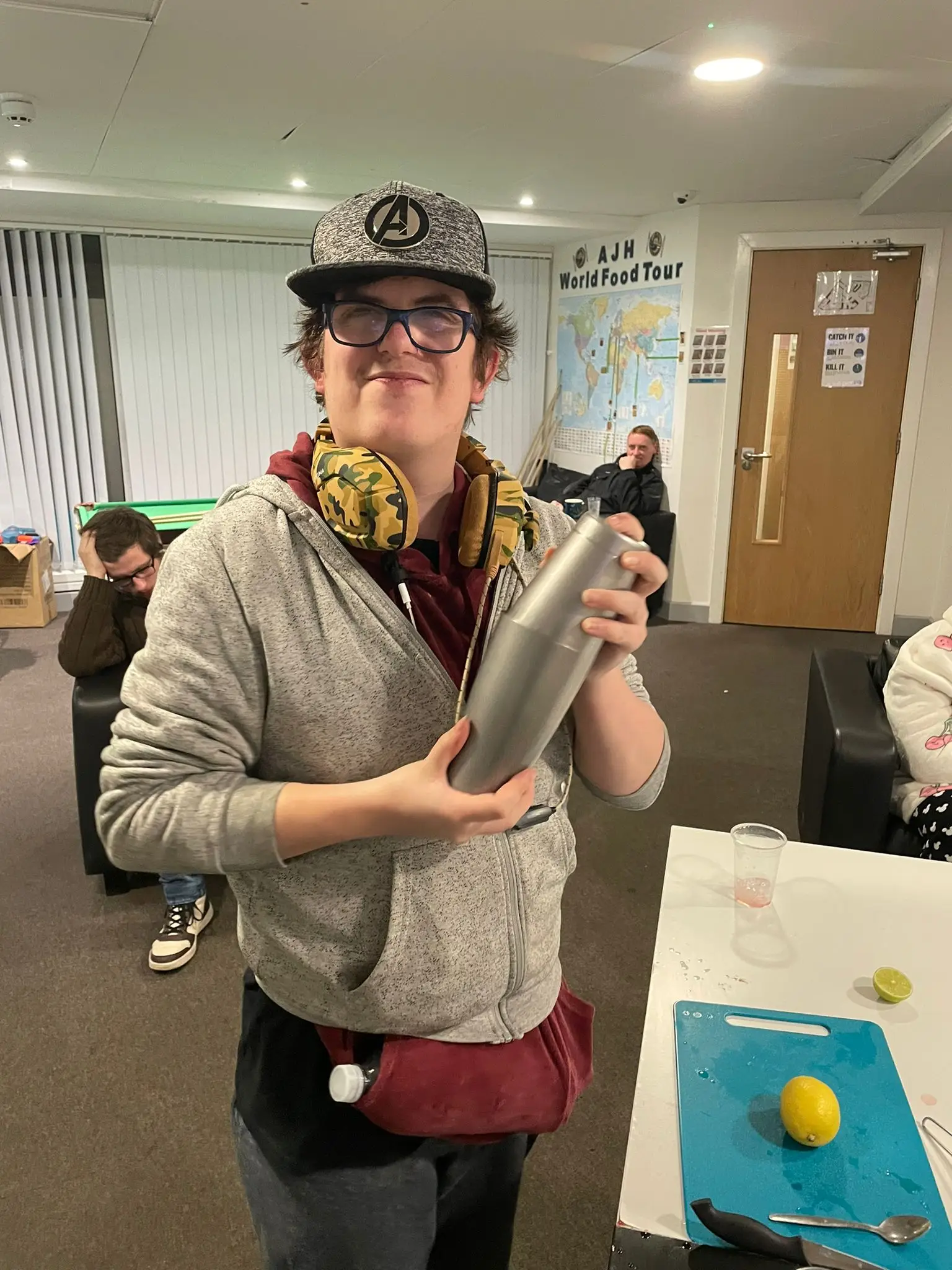 resident holding silver cocktail shaker