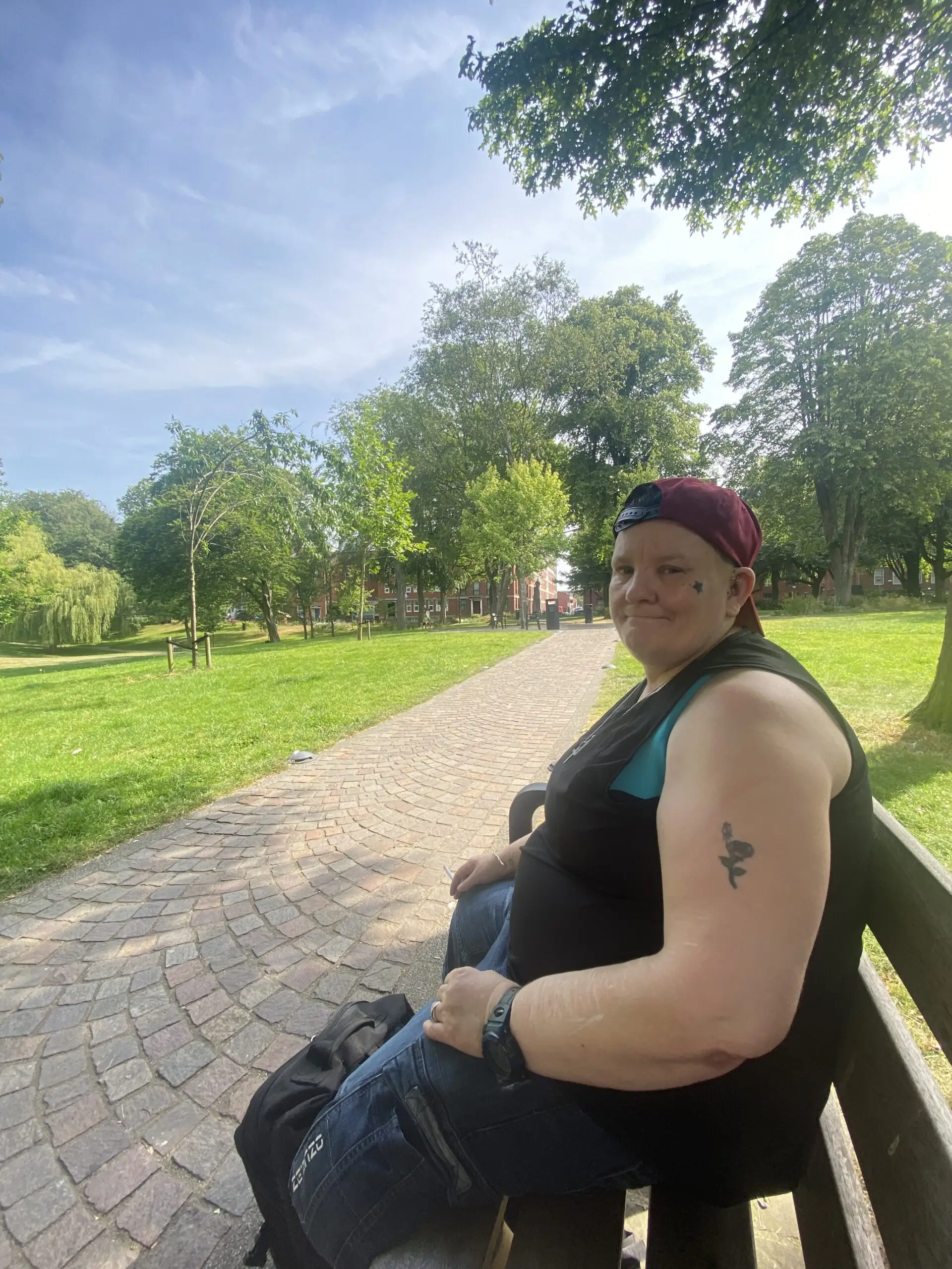 resident sitting on park bench