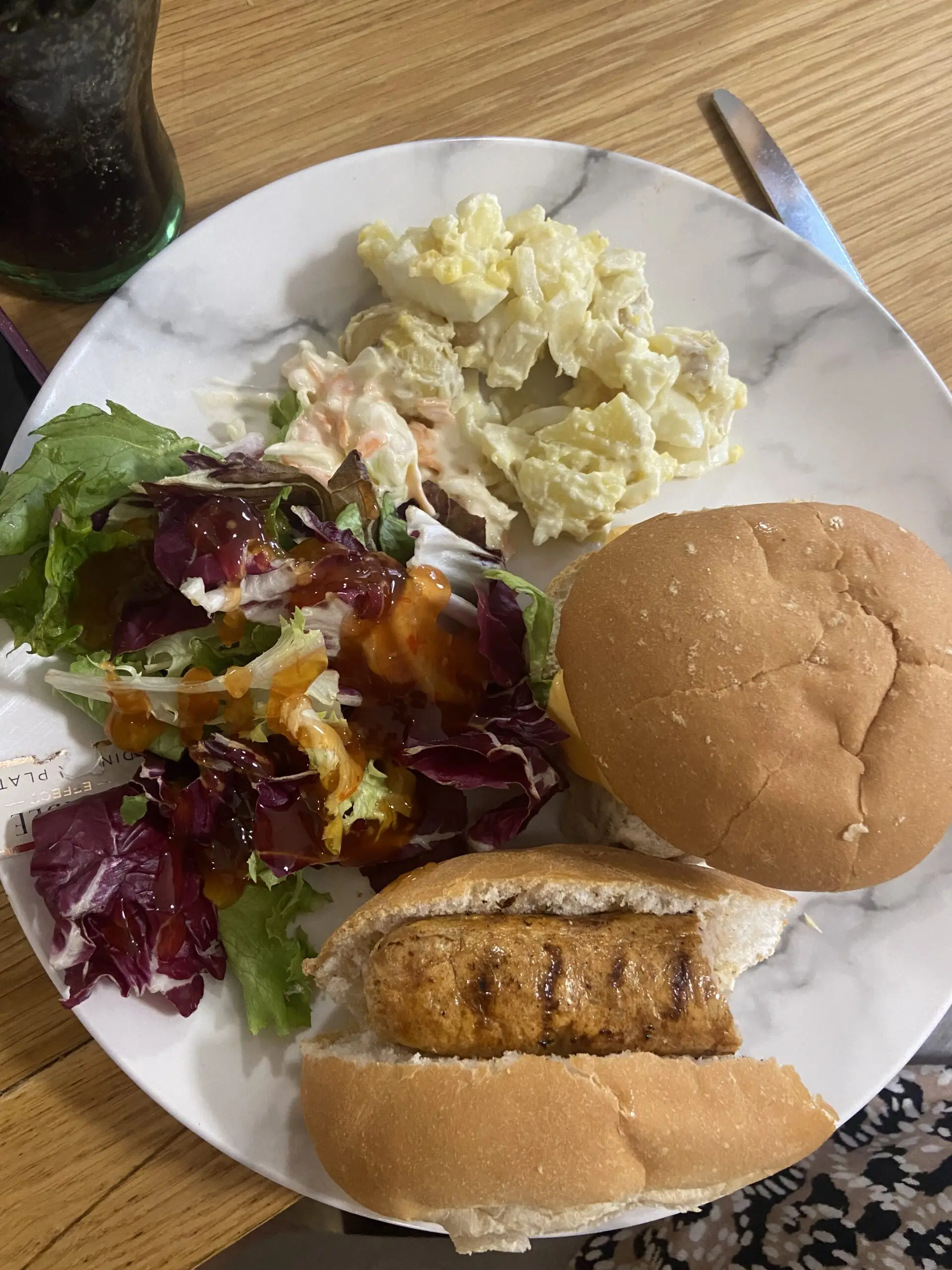 plate with burgers, hot dogs and salad