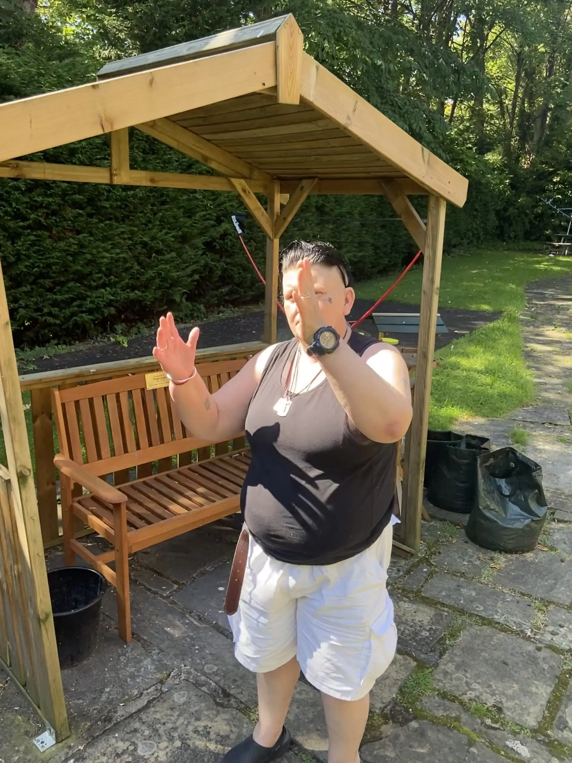 resident outdoors in front of bench