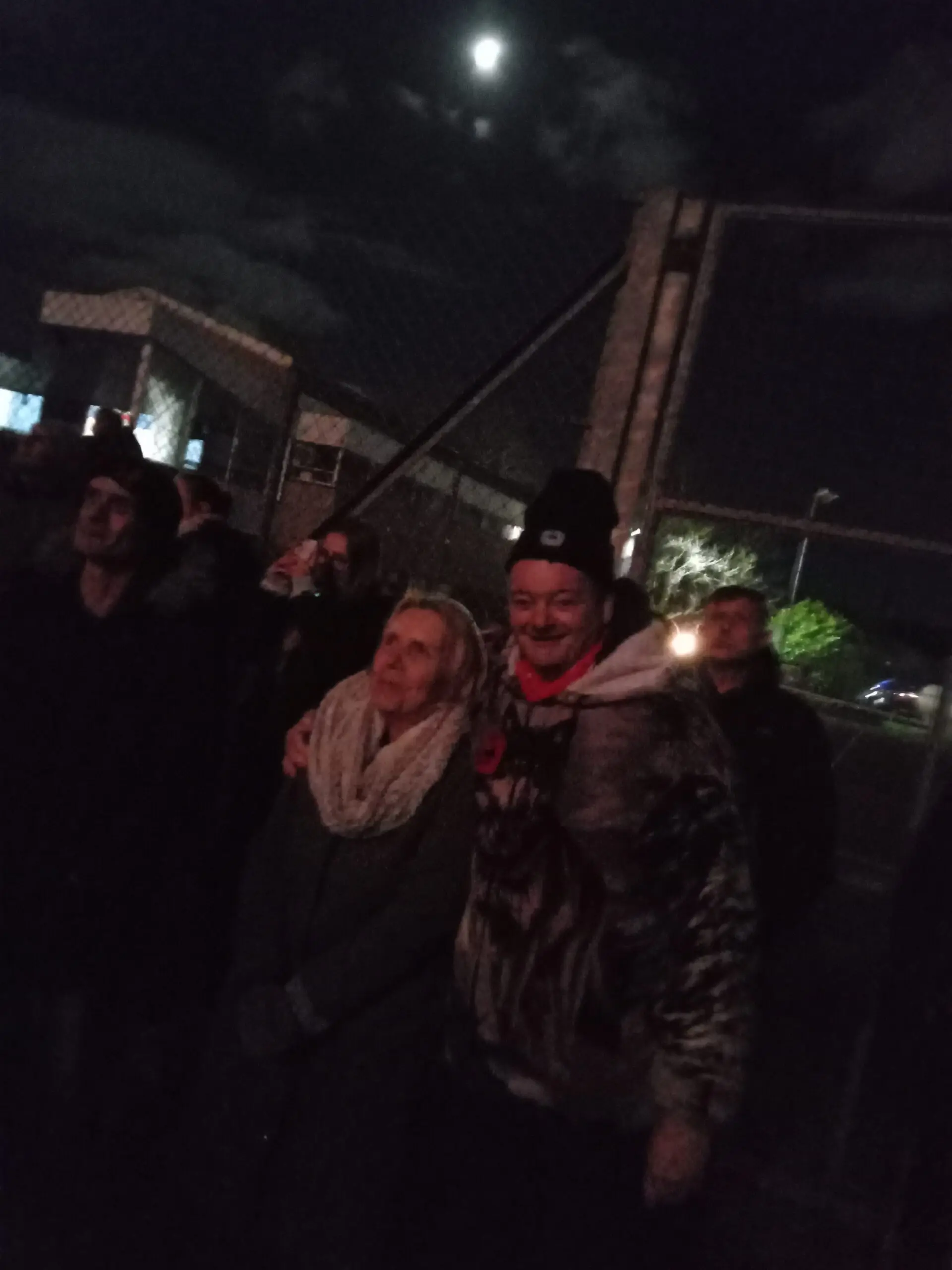 residents outdoors wrapped up warm watching fireworks