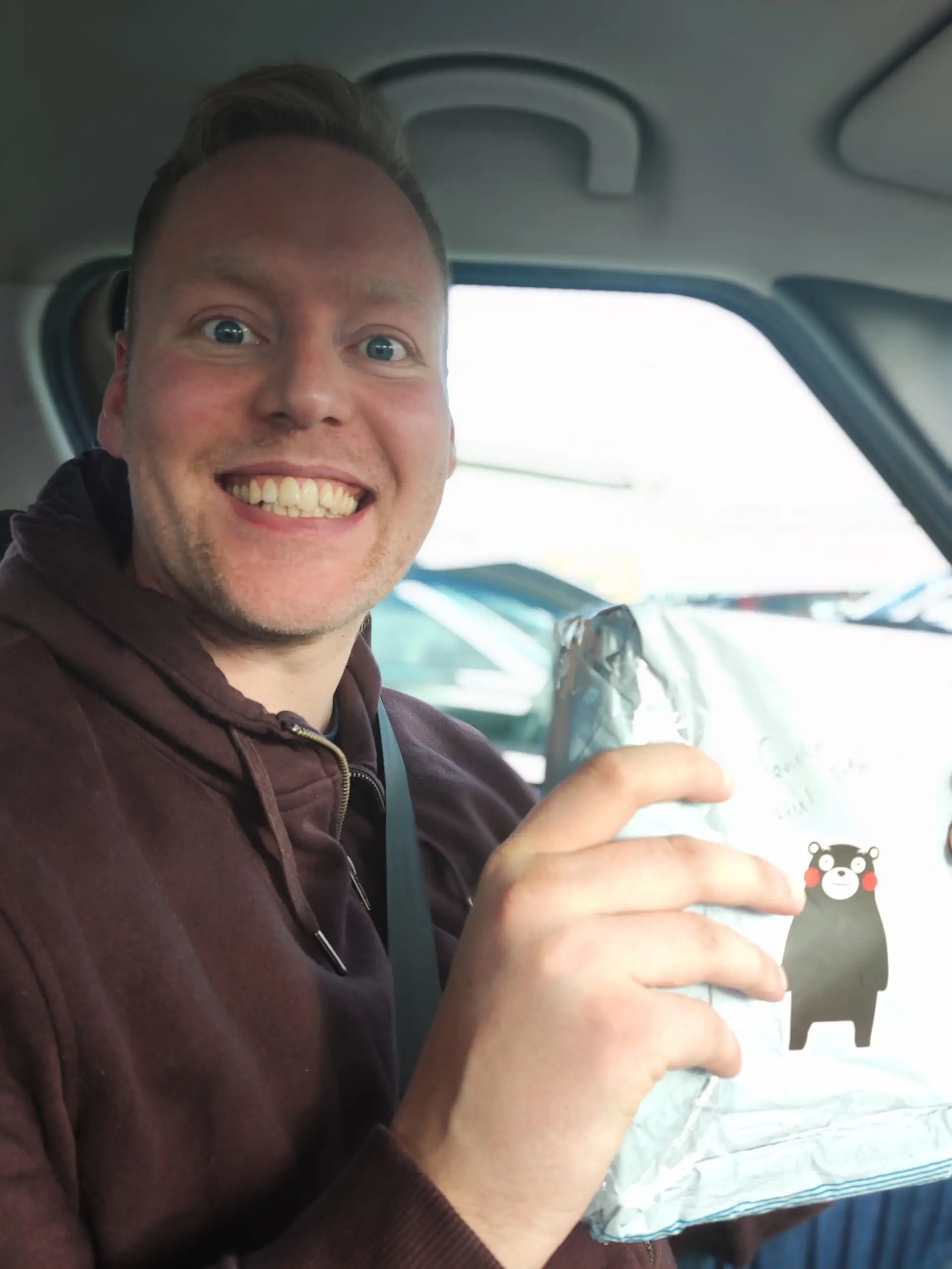 resident smiling and holding kindness package