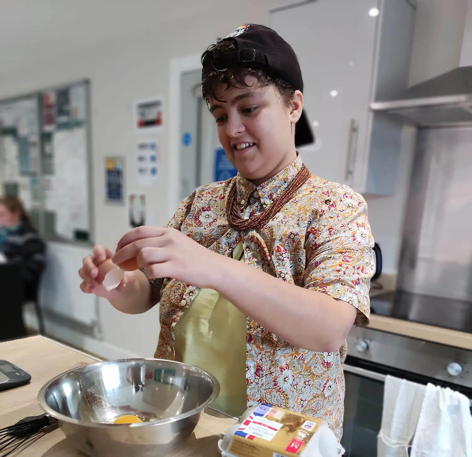 resident preparing cake mixture in bowl