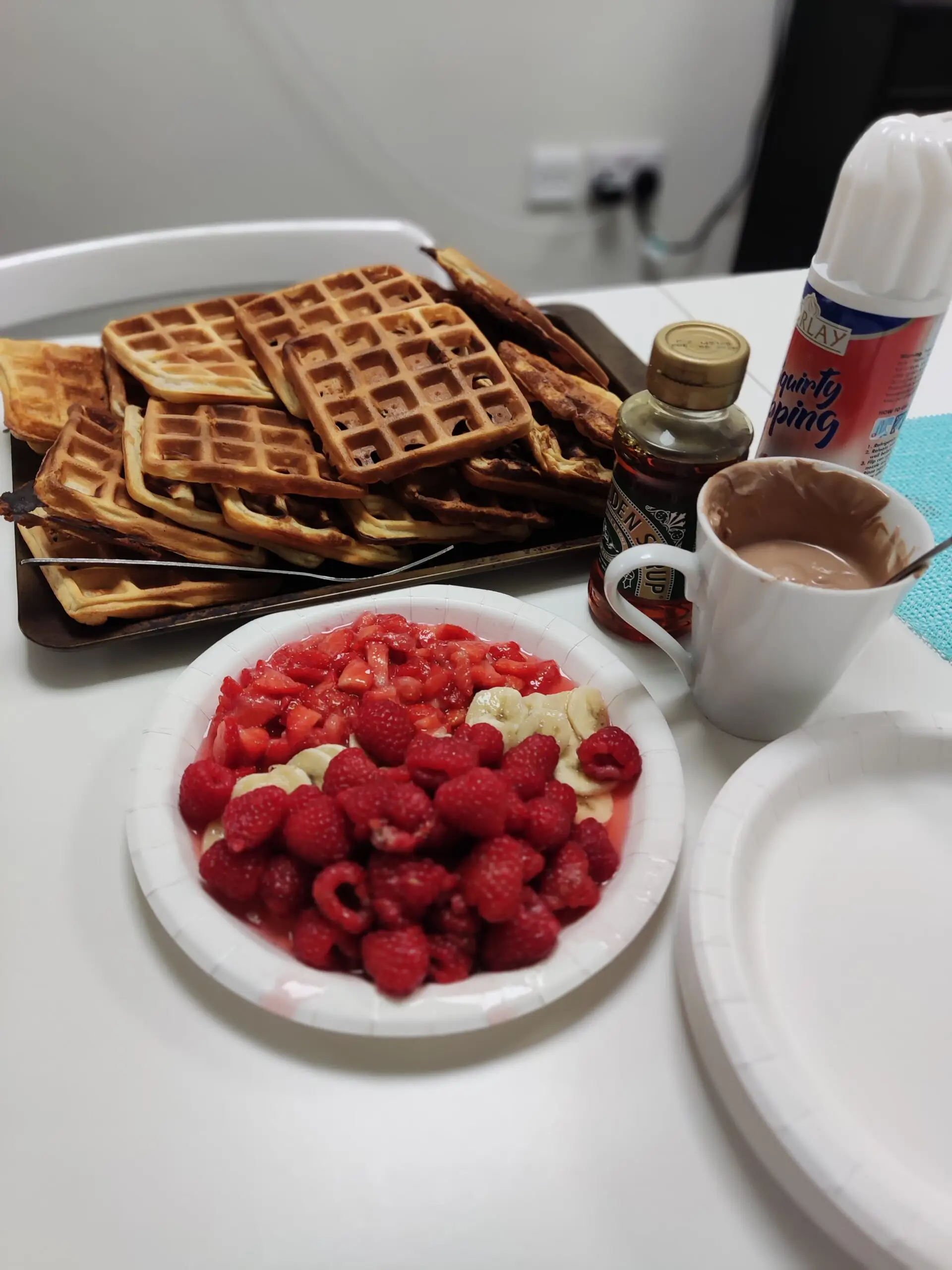 plate of waffles and plate of raspberries