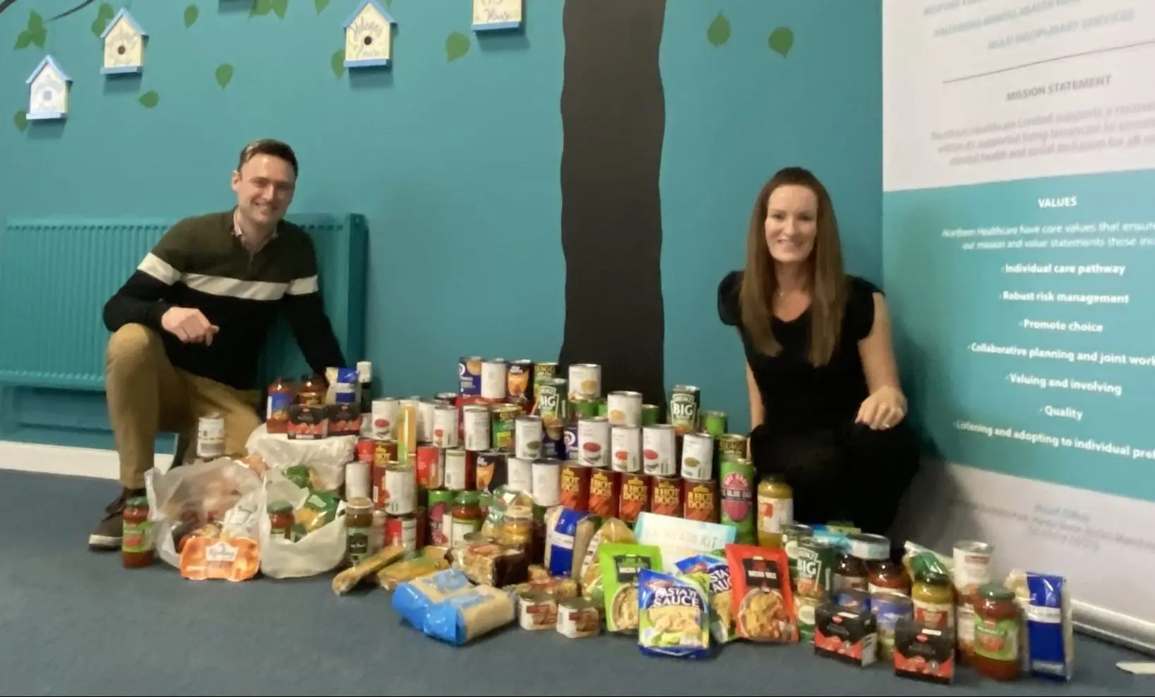 Directors next to Food Bank Donations