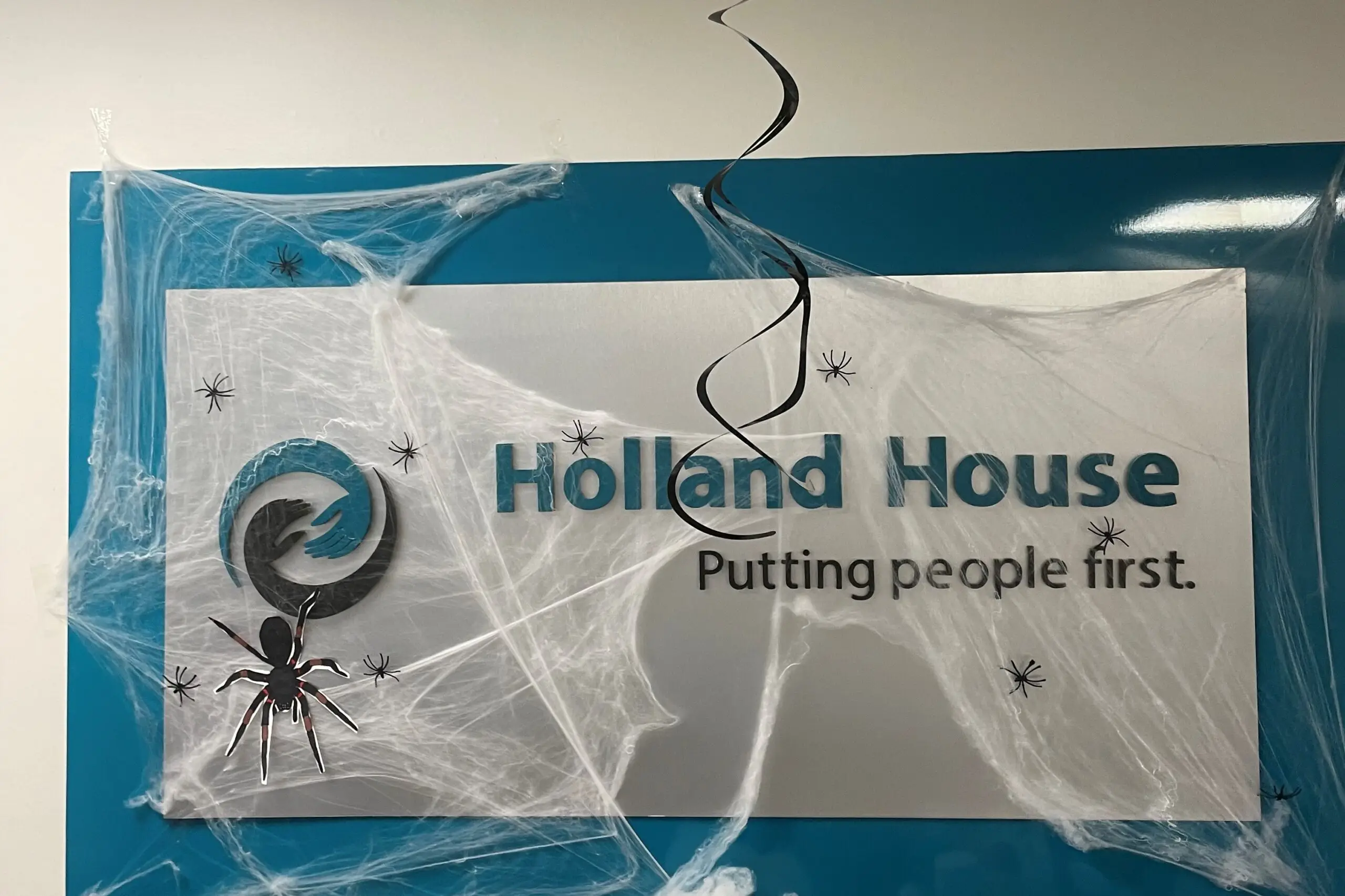 Holland House sign covered in fake cobwebs