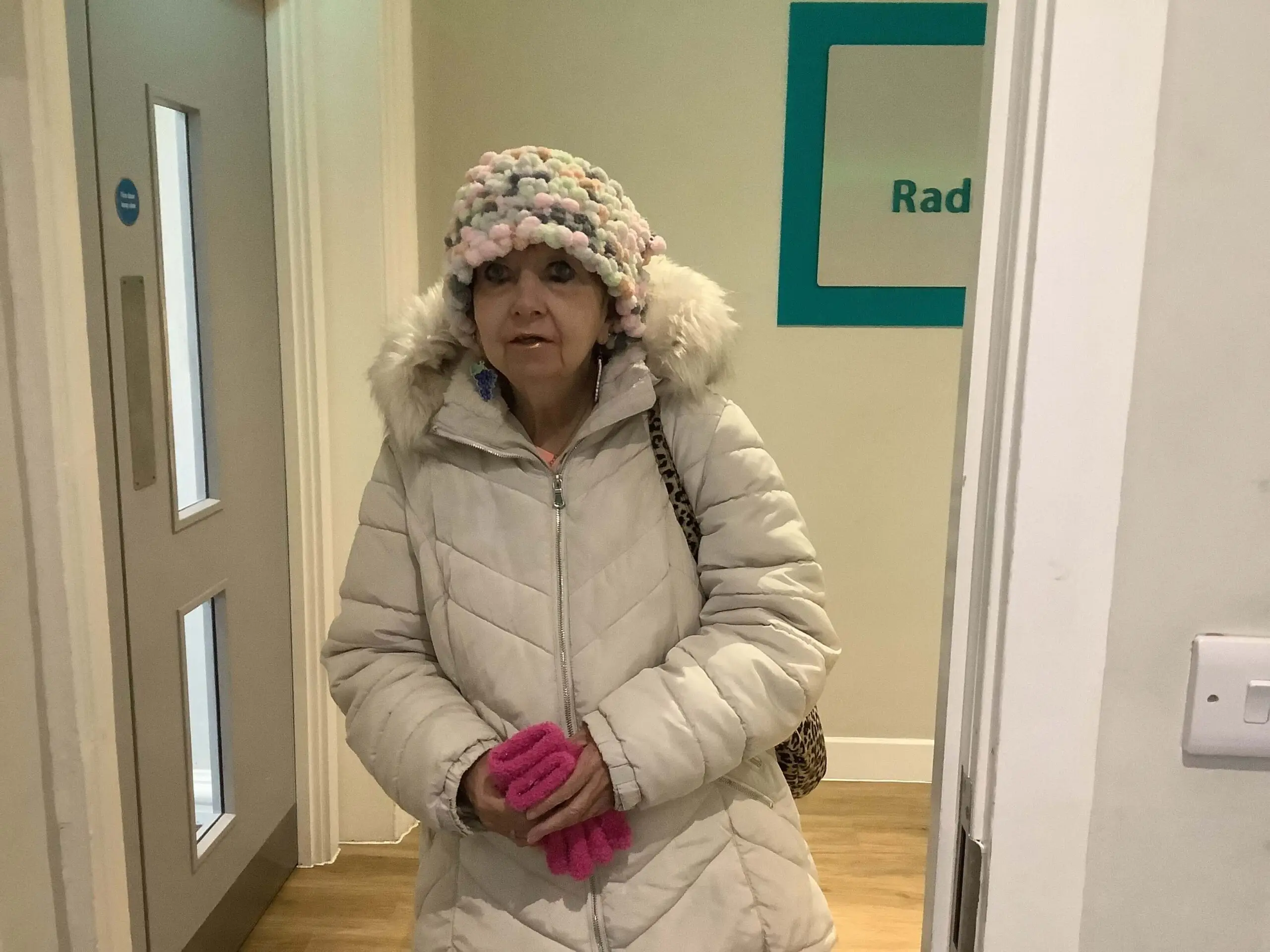 resident wrapped up warm wearing the hat she has knitted