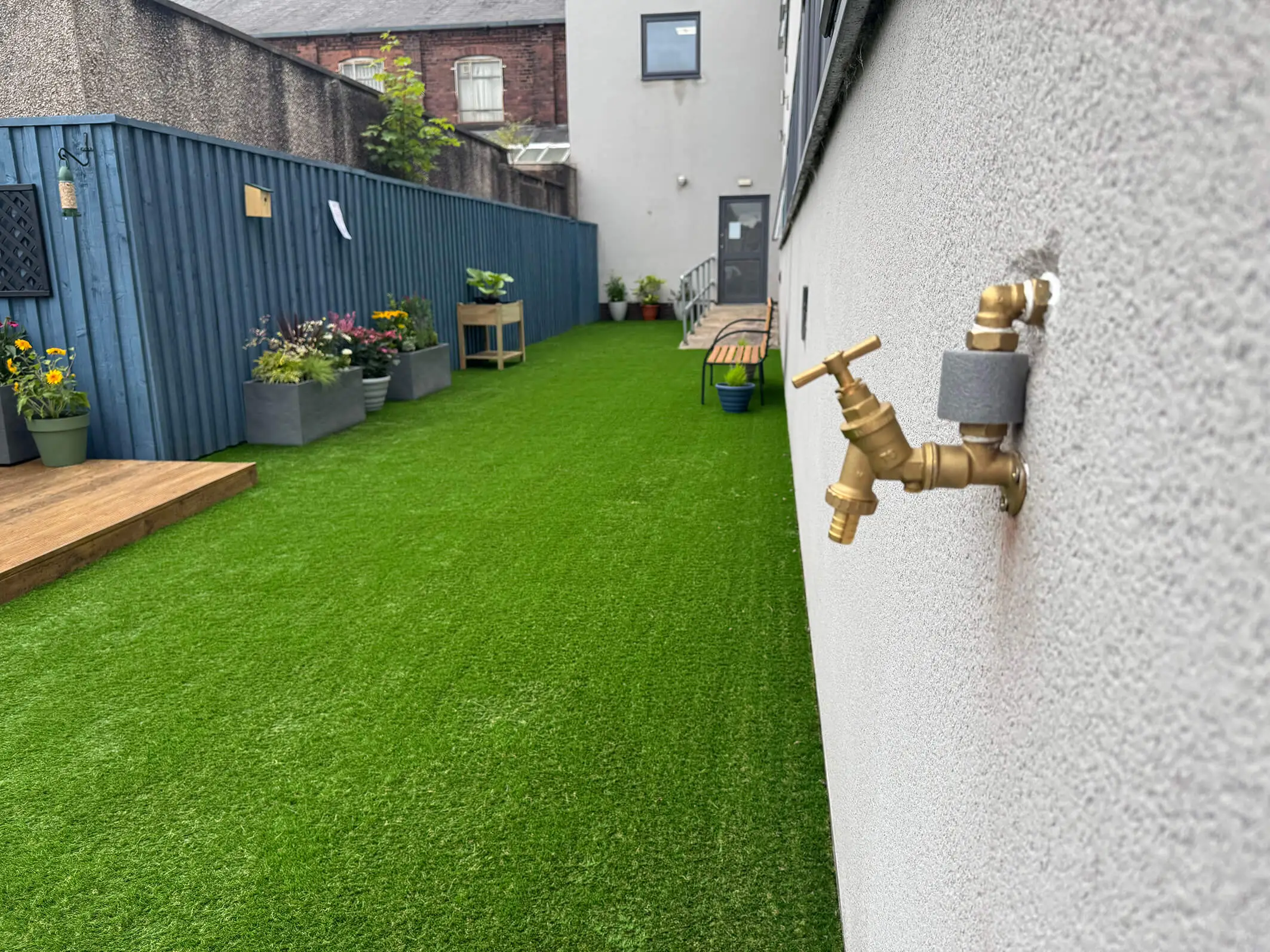 The final result of the garden makeover and renovation at Montgomery House in Bury, Greater Manchester, showing a new grassy area.