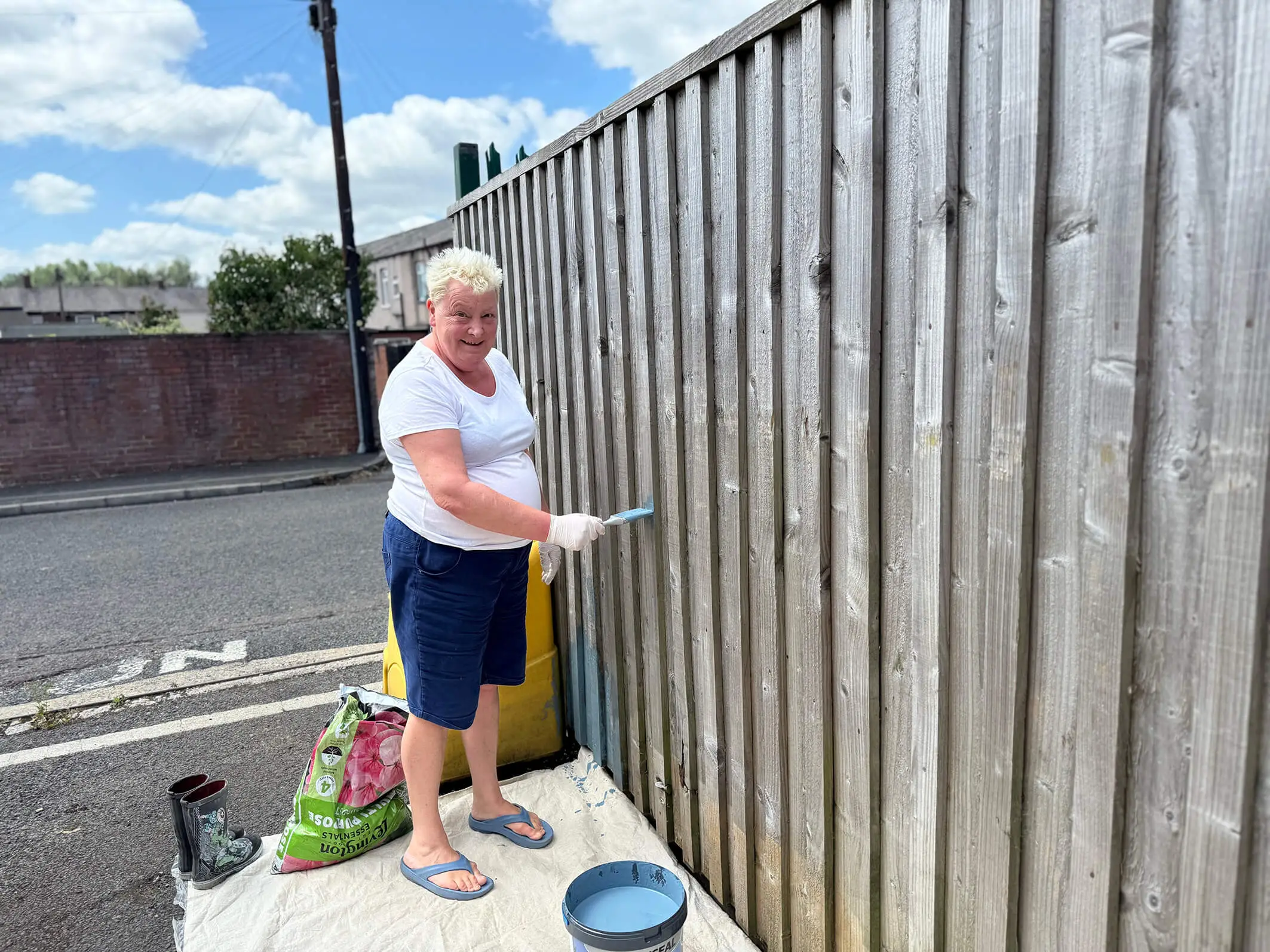 A person we support at Montgomery House in Bury, Greater Manchester, working hard on the garden renovation.