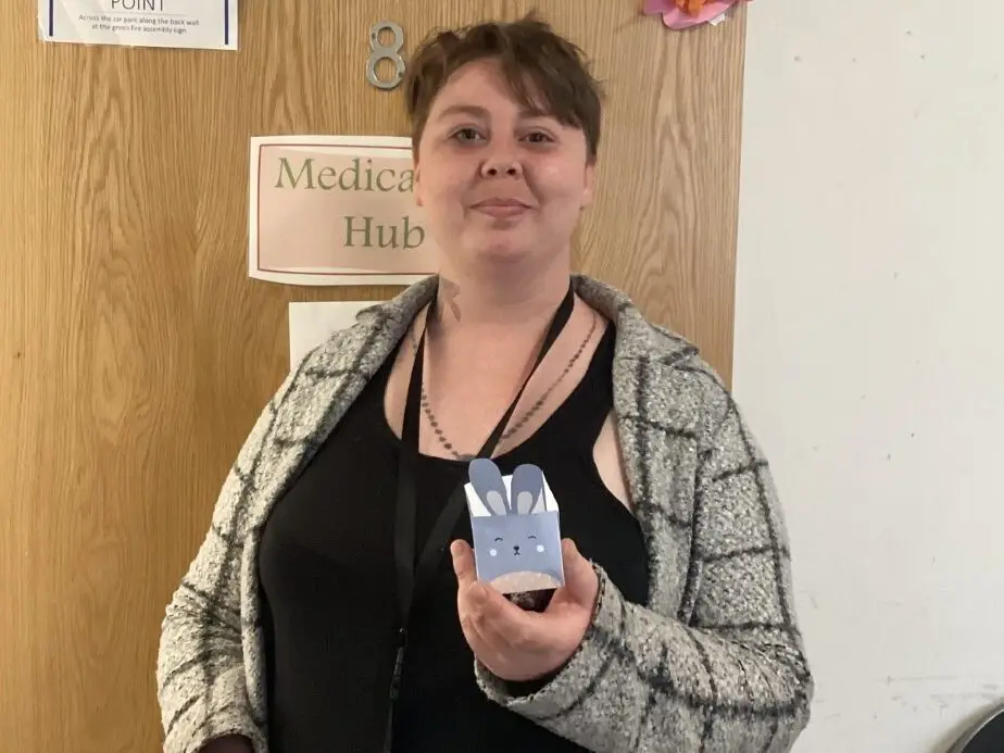 female resident holding paper bunny