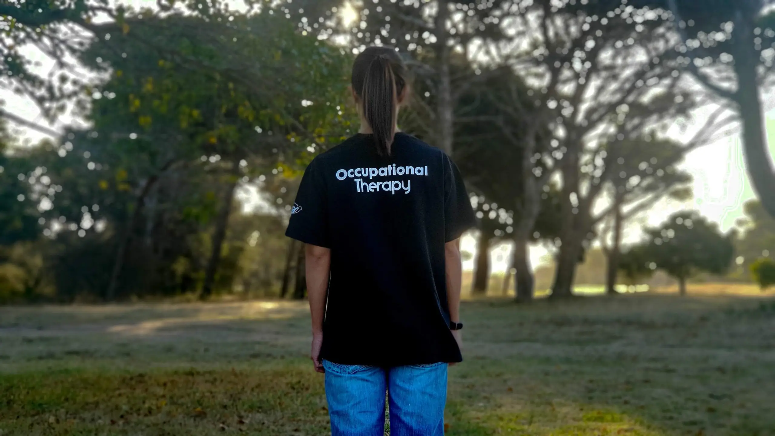 occuaptional therapy student standing in woods