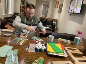 A resident enjoying arts and crafts