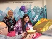 Resident blowing out candles on birthday cake