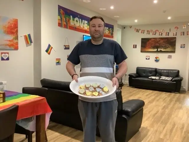 Gentleman holding Pride cupcakes