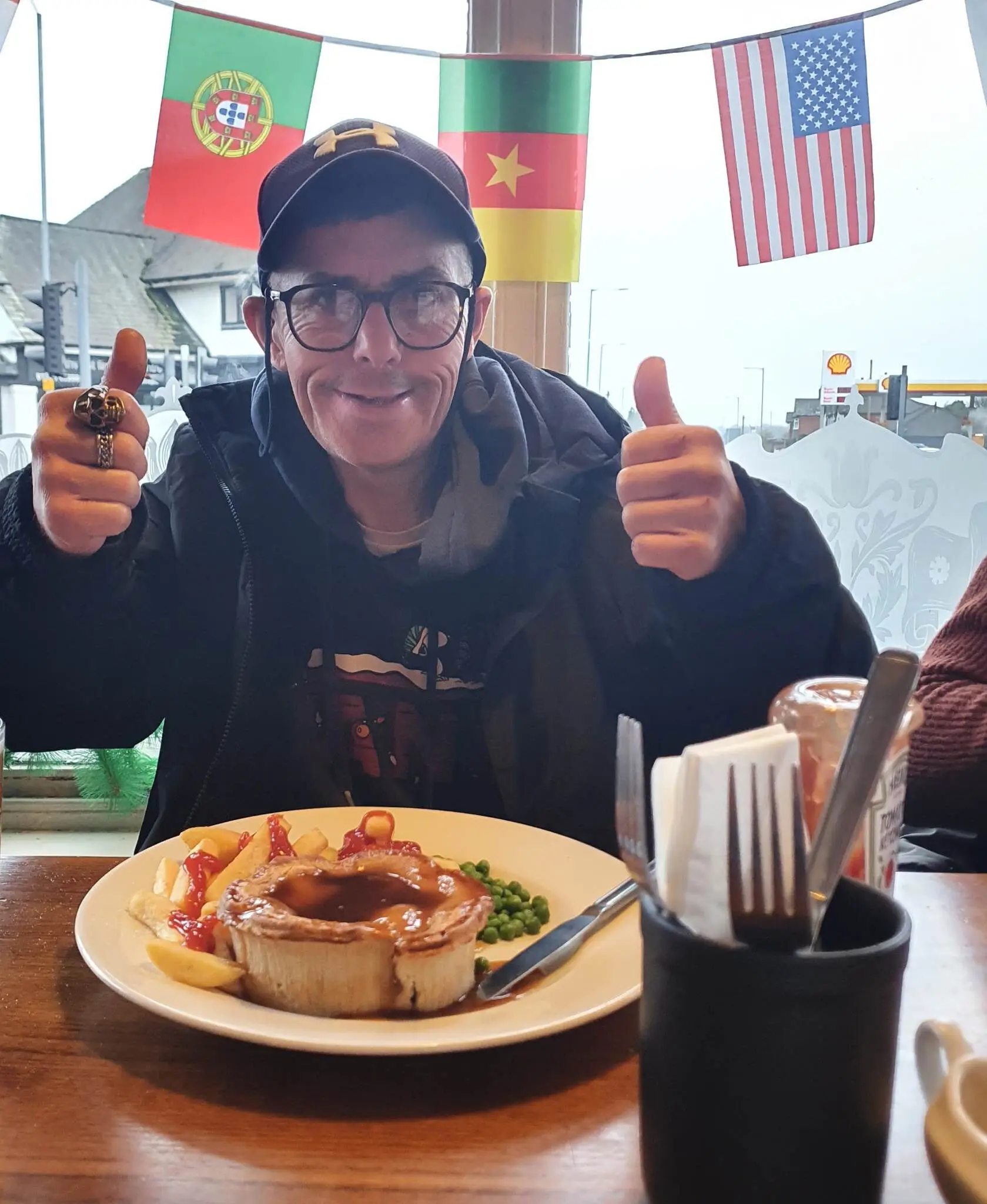 resident sitting at table with meal and thumbs up