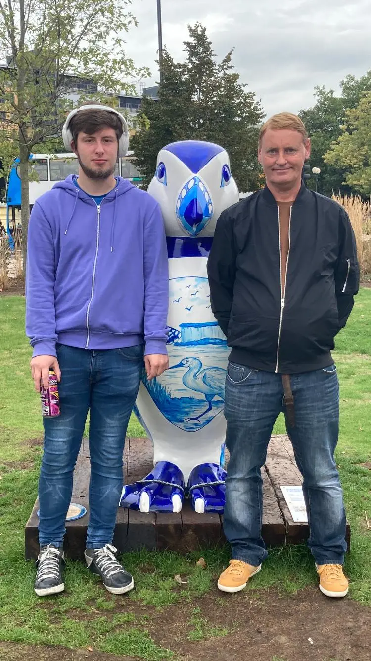residents with puffin statue