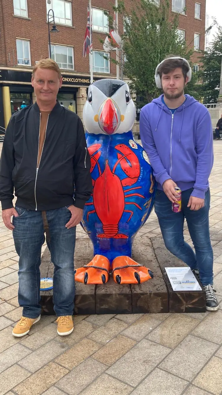 residents with puffin statue