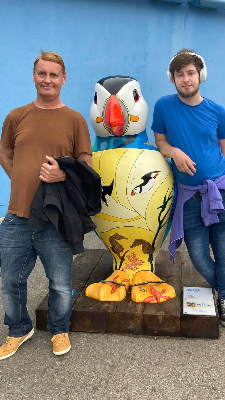 residents with puffin statue