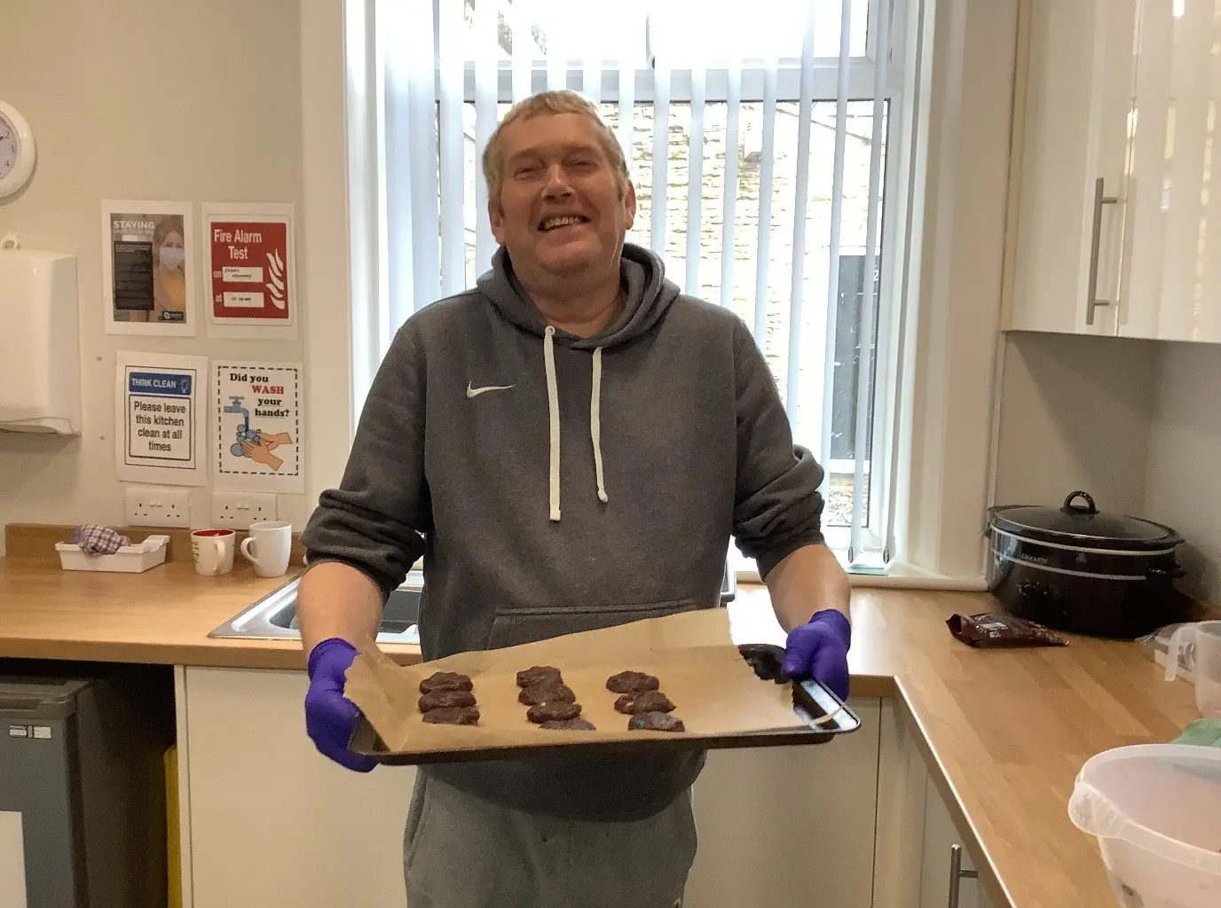 resident holding tray of homemade cookies