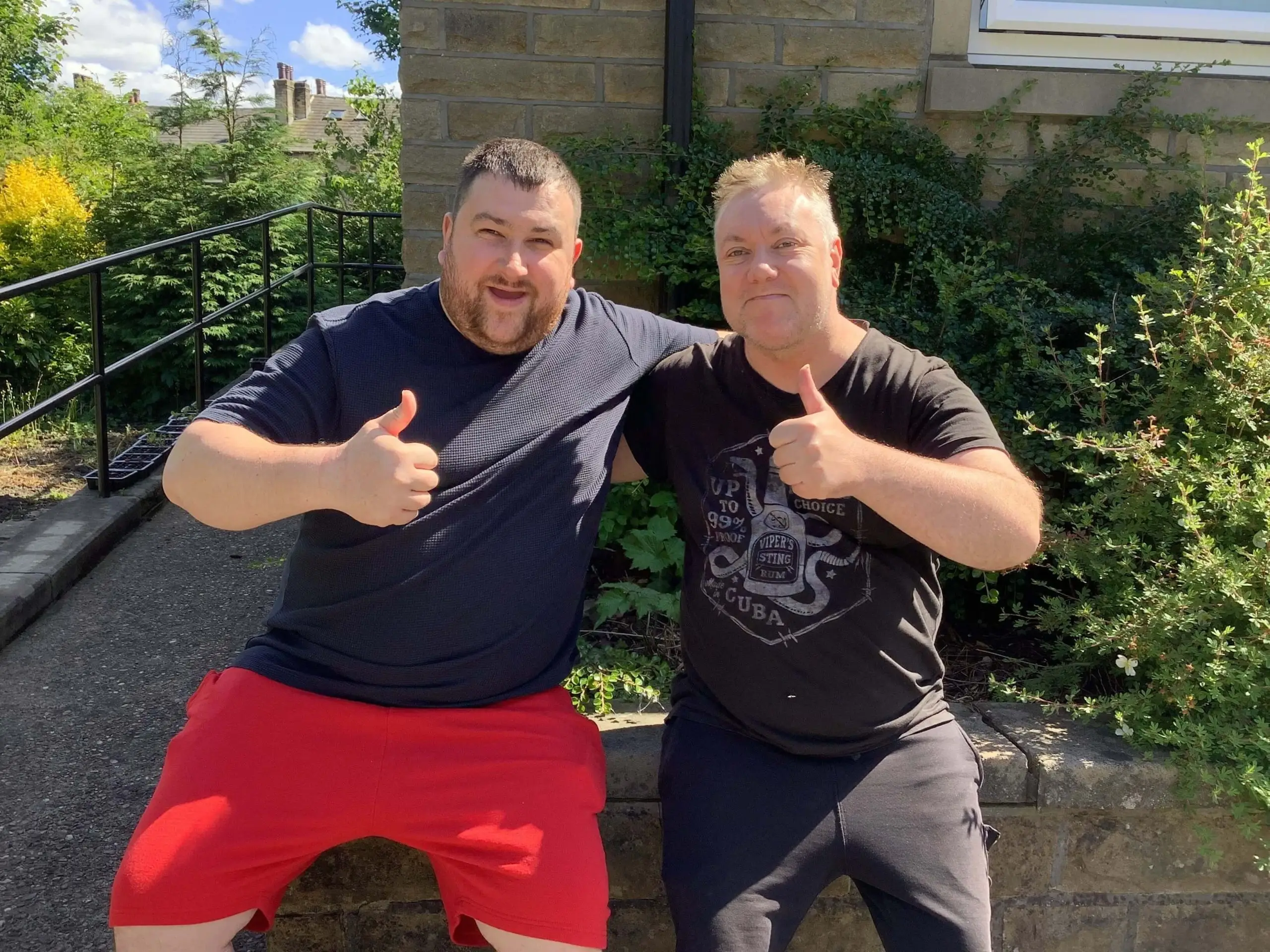 Two gentleman giving thumps up