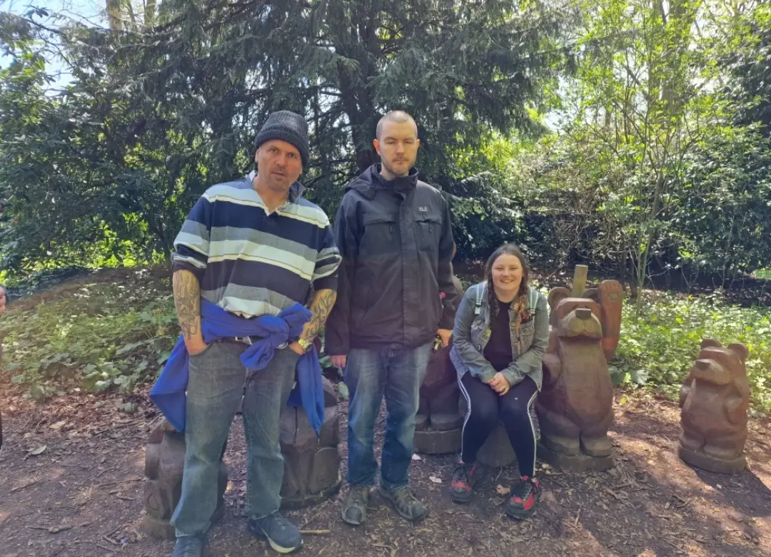 residents with wooden bear carvings