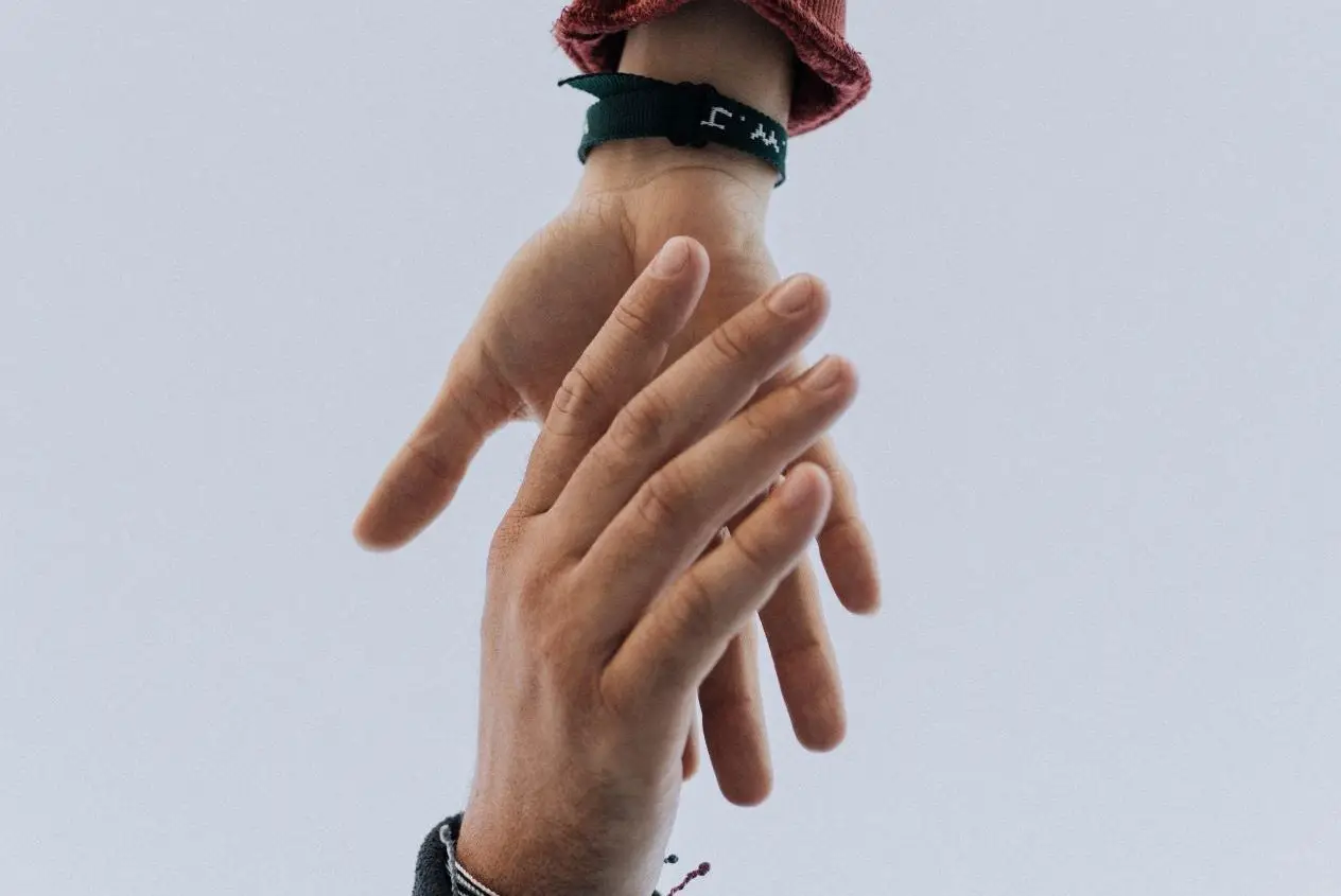 Two people reaching for each other