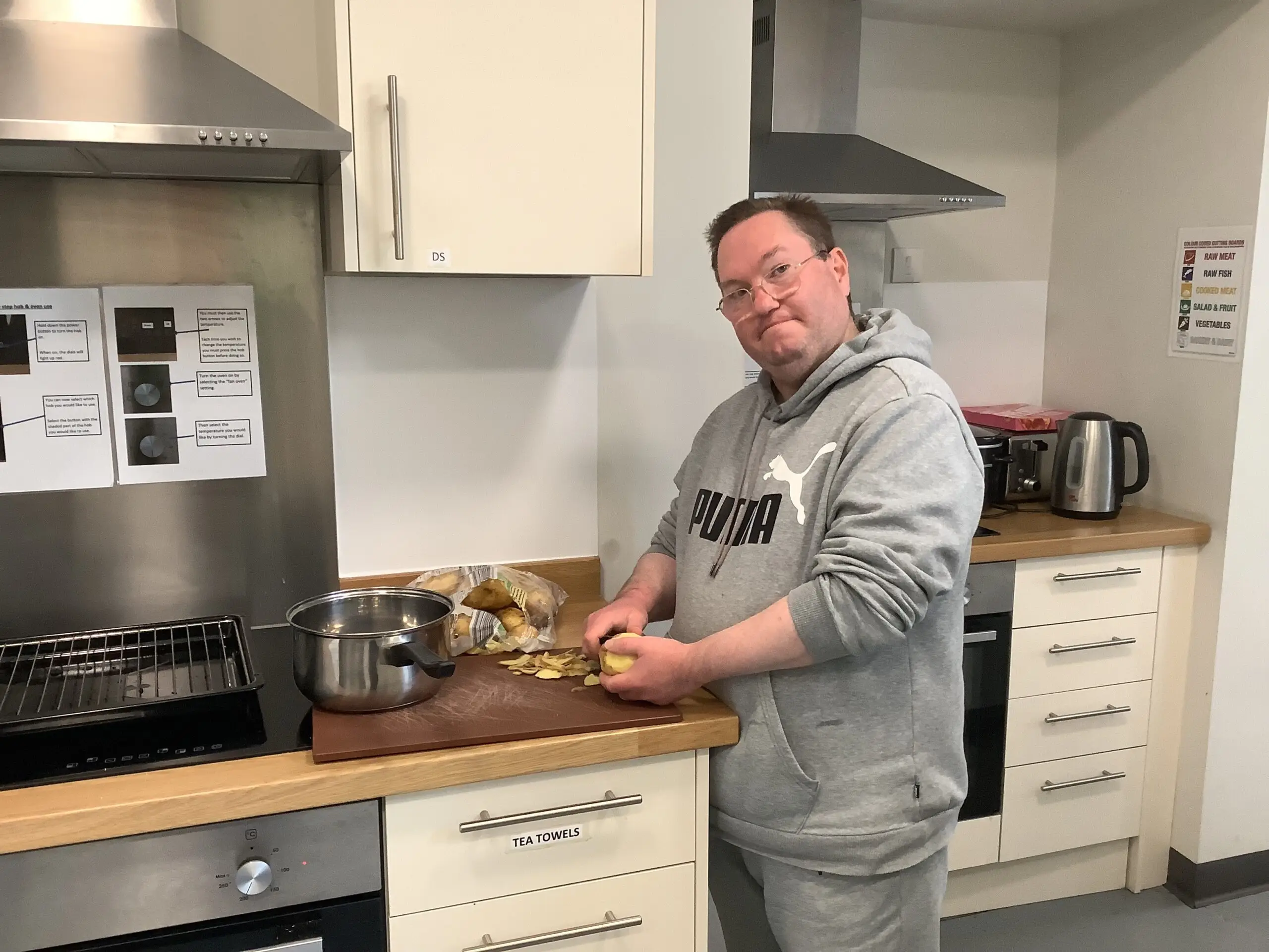 male resident peeling potatoes