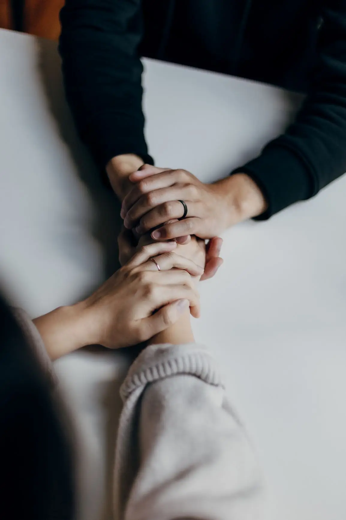 two people with hands clasped