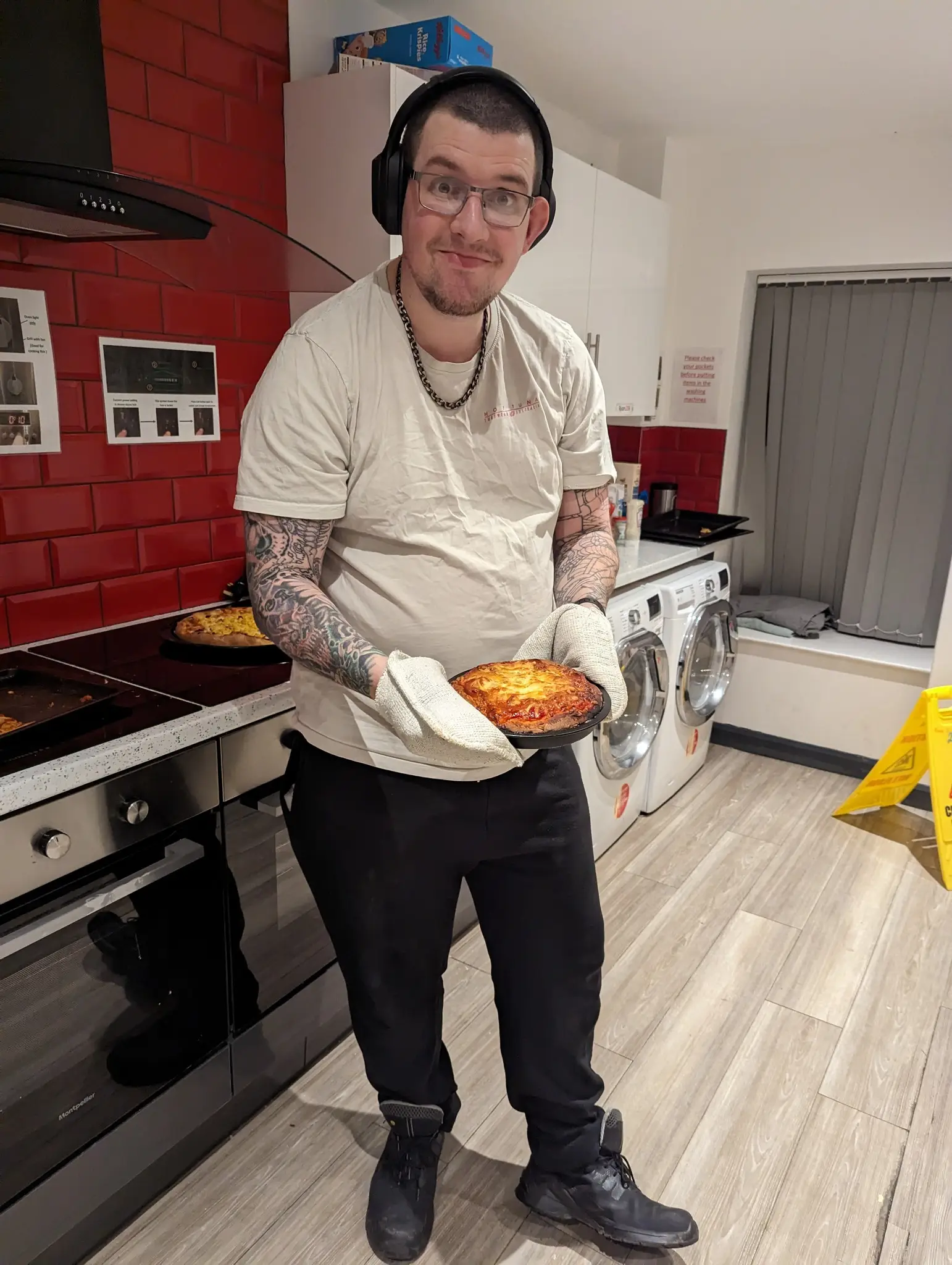 Male resident holding mini pizza