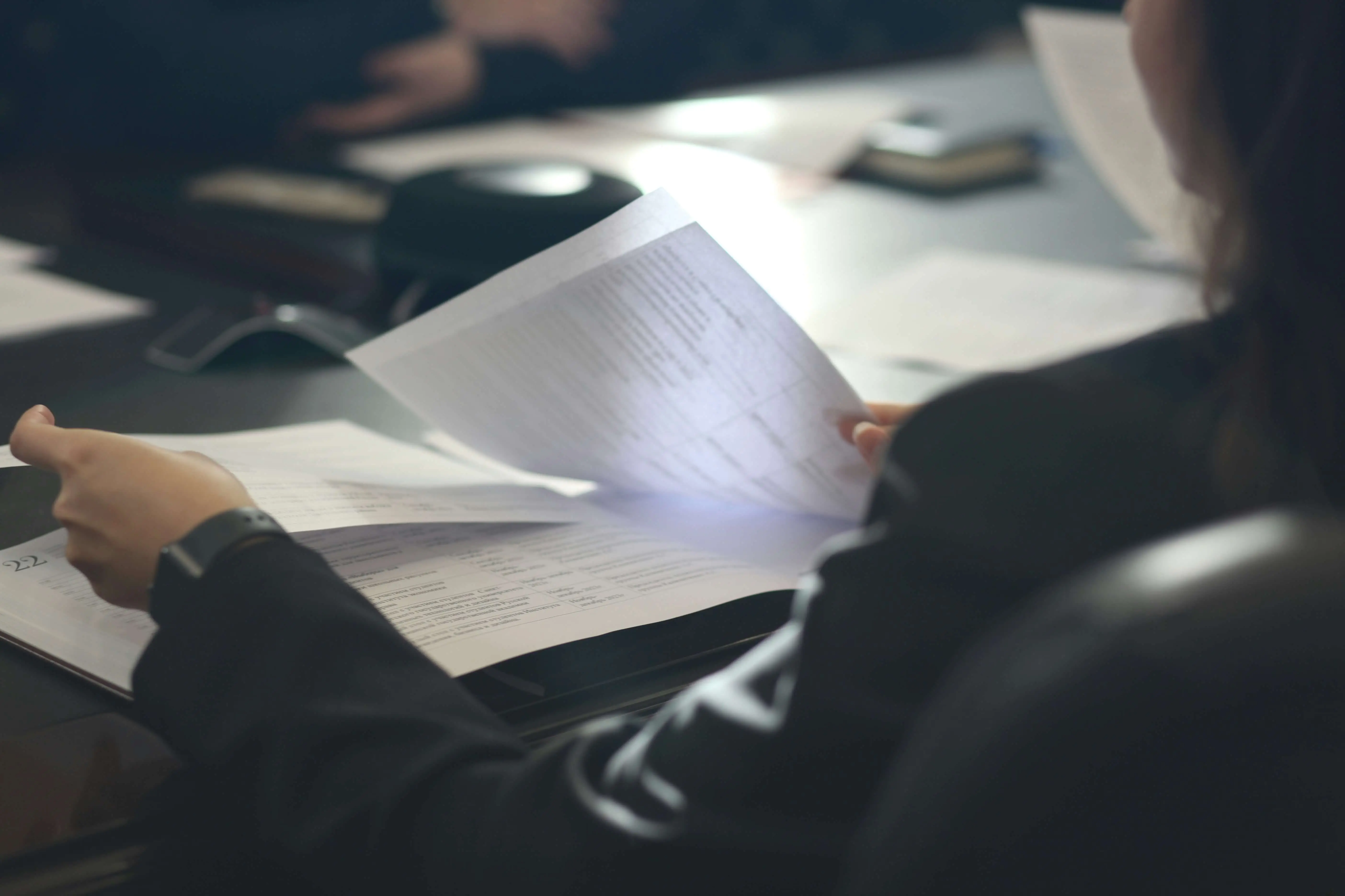 Person looking at paperwork for news of the Government's Supported Housing regulation and consultation.